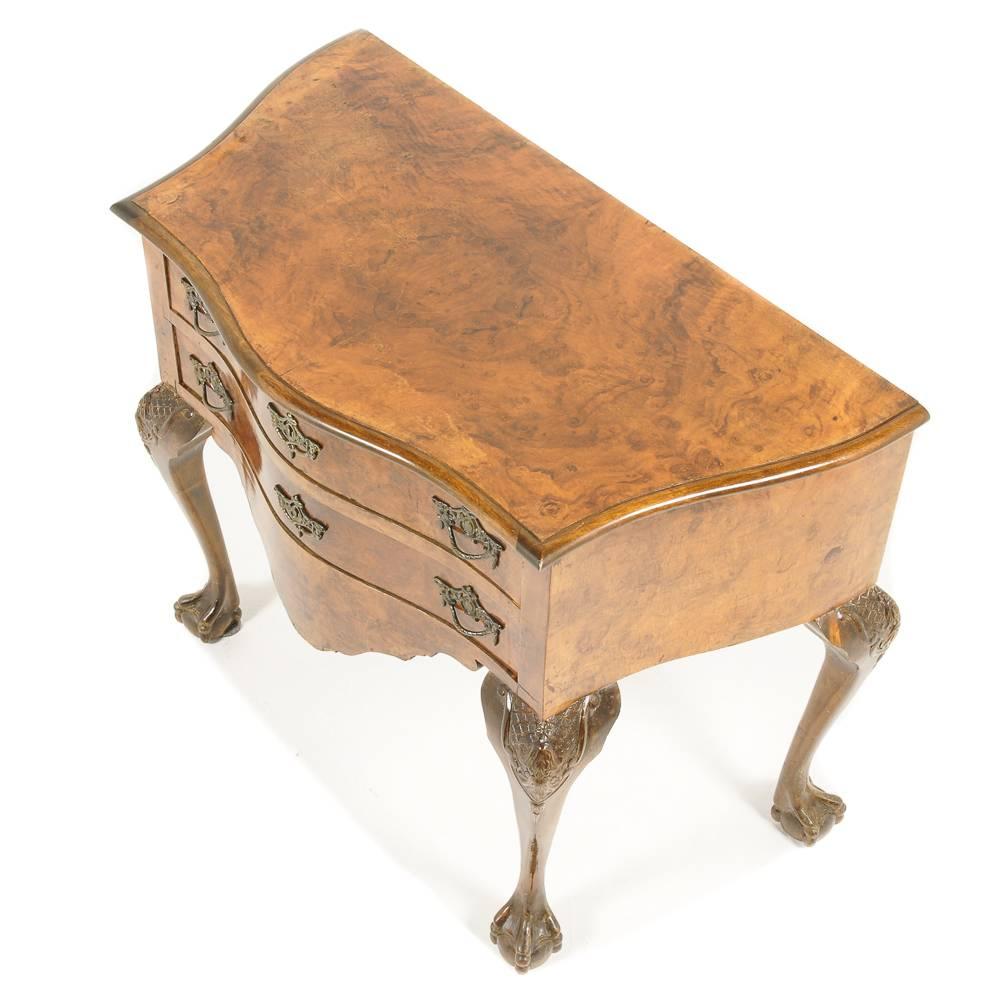 Dutch two-drawer, burl walnut “Lowboy” cabinet. Distinctive “V” shape front, with cabriole ball-and-claw legs. Finished with ornate brass accoutrements, circa 1930. Its smaller size makes it an ideal candidate for a number of locations throughout