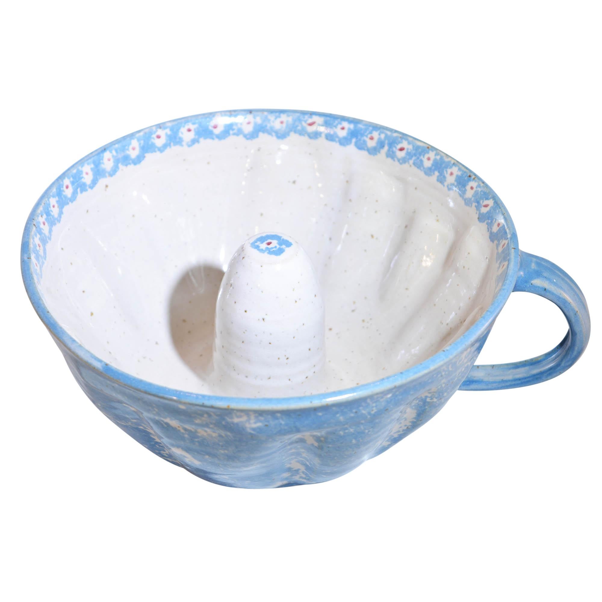 Handcrafted cake plate and bundt cake form are works of AnnA Maria Preuss. The 12.5” cake plate is hand decorated with a floral design and has AnnA’s mark on the bottom. The coordinating bundt form is hand painted blue on the outside and features