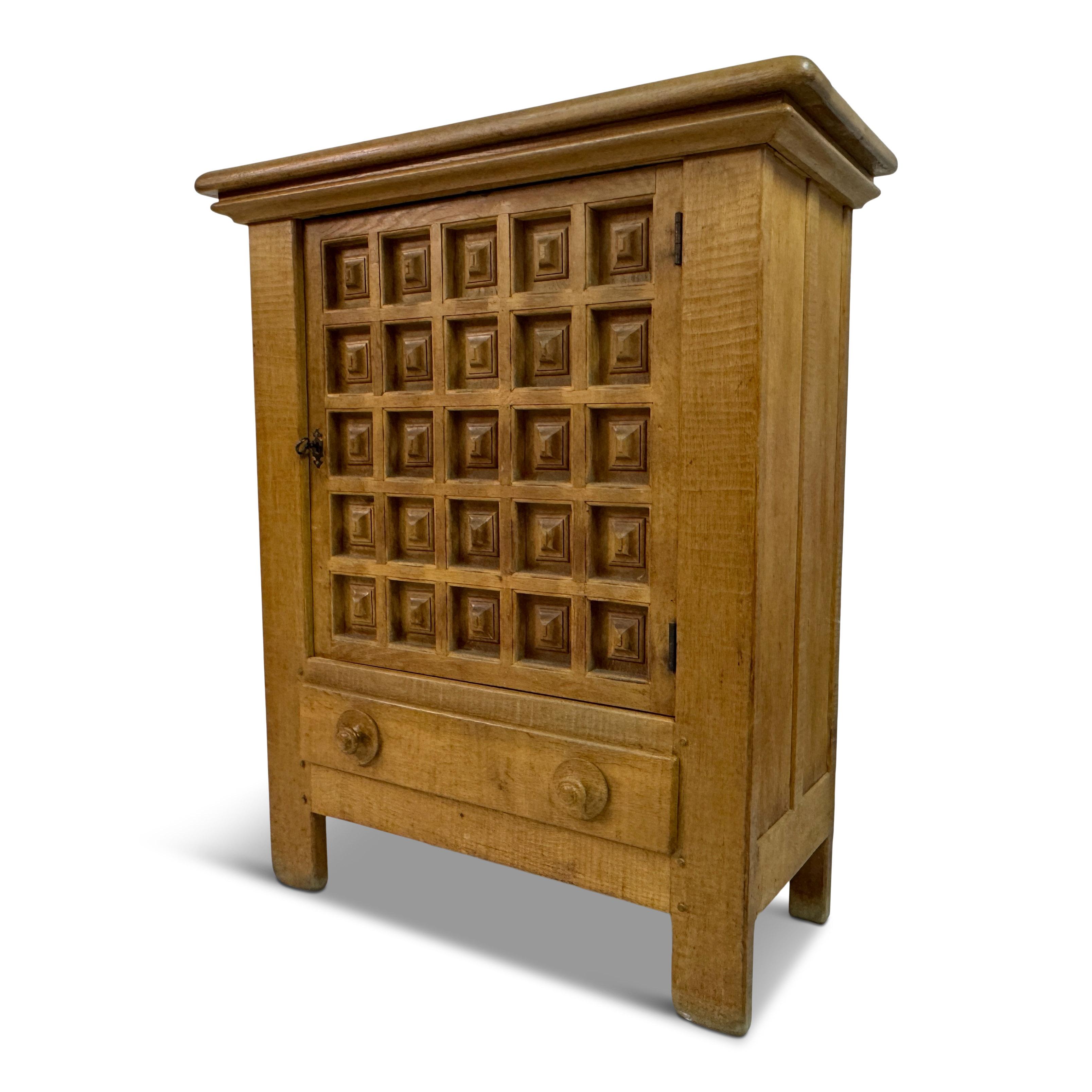 Dutch Carved Oak Cupboard, 1960s

A boldly graphic oak cupboard from the Netherlands, circa 1960s, distinguished by its deeply carved door front of repeated square pyramidal motifs. The composition feels both ancient and modern—its relief pattern