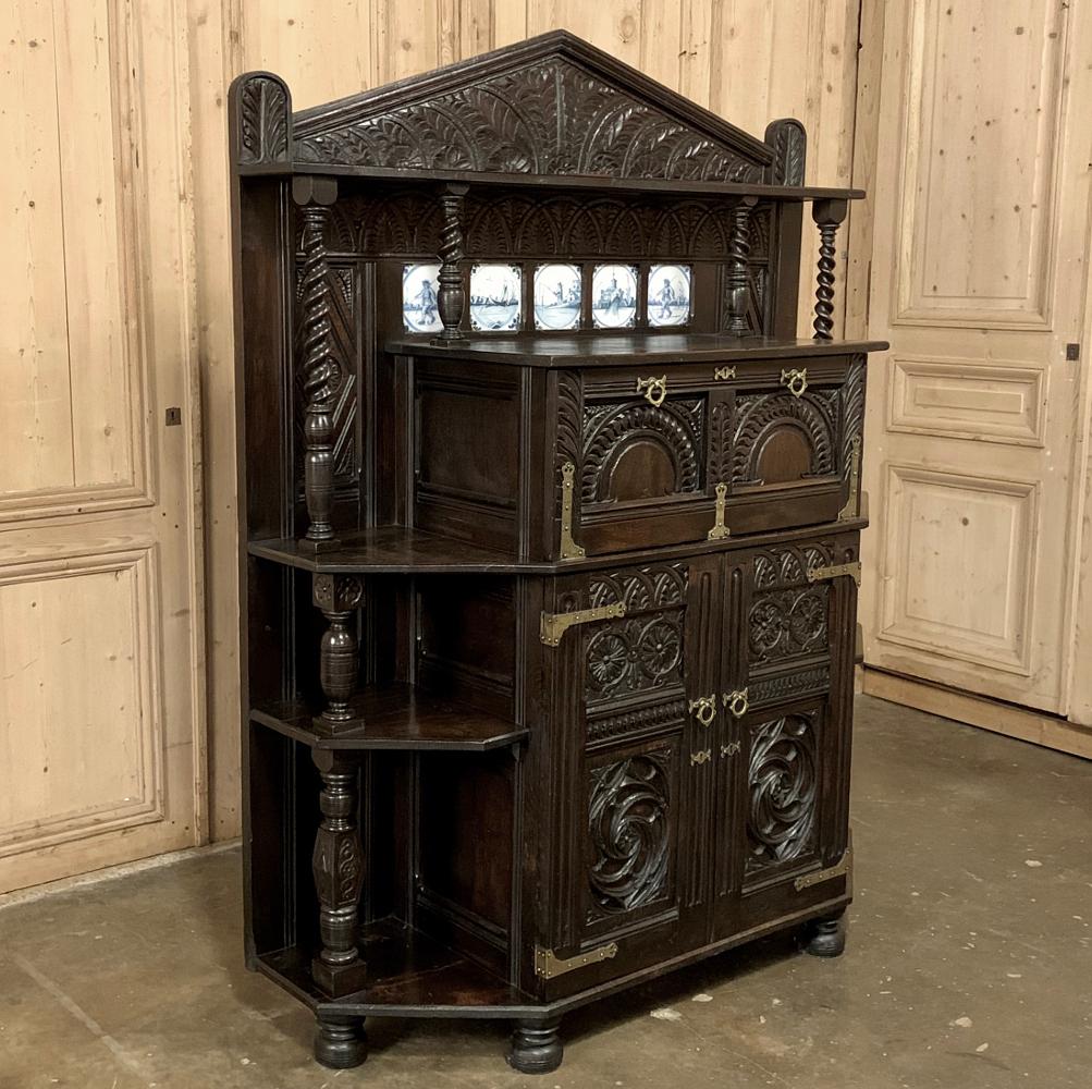 18th century Dutch Renaissance cabinet is an unusual combination of exquisite craftsmanship, open shelving, cabinetry and timeless architecture! Hand carved from old-growth oak, it features a Grecian style crown with delft tiles inset into the