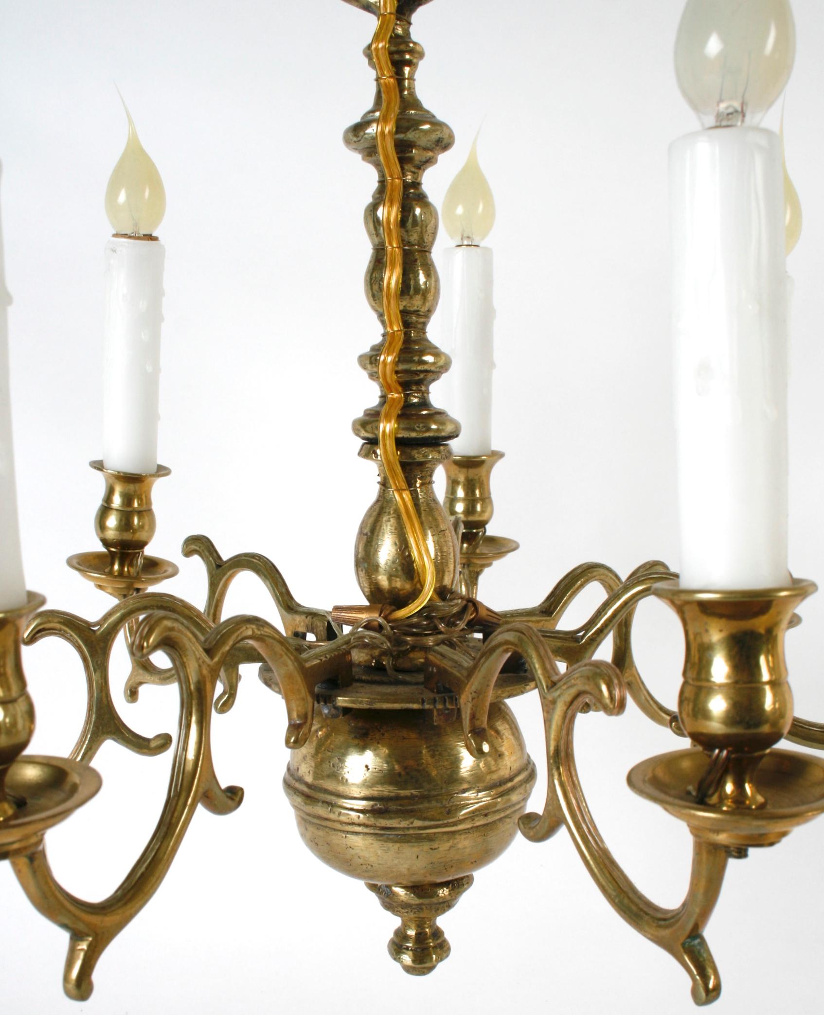 Dutch colonial 7-light brass chandelier with pegged, scrolled arms on bulbous turned shaft. This has a beautiful, mellow patina with great proportions. It has been surface wired to US standards and holds seven candelabra bulbs.