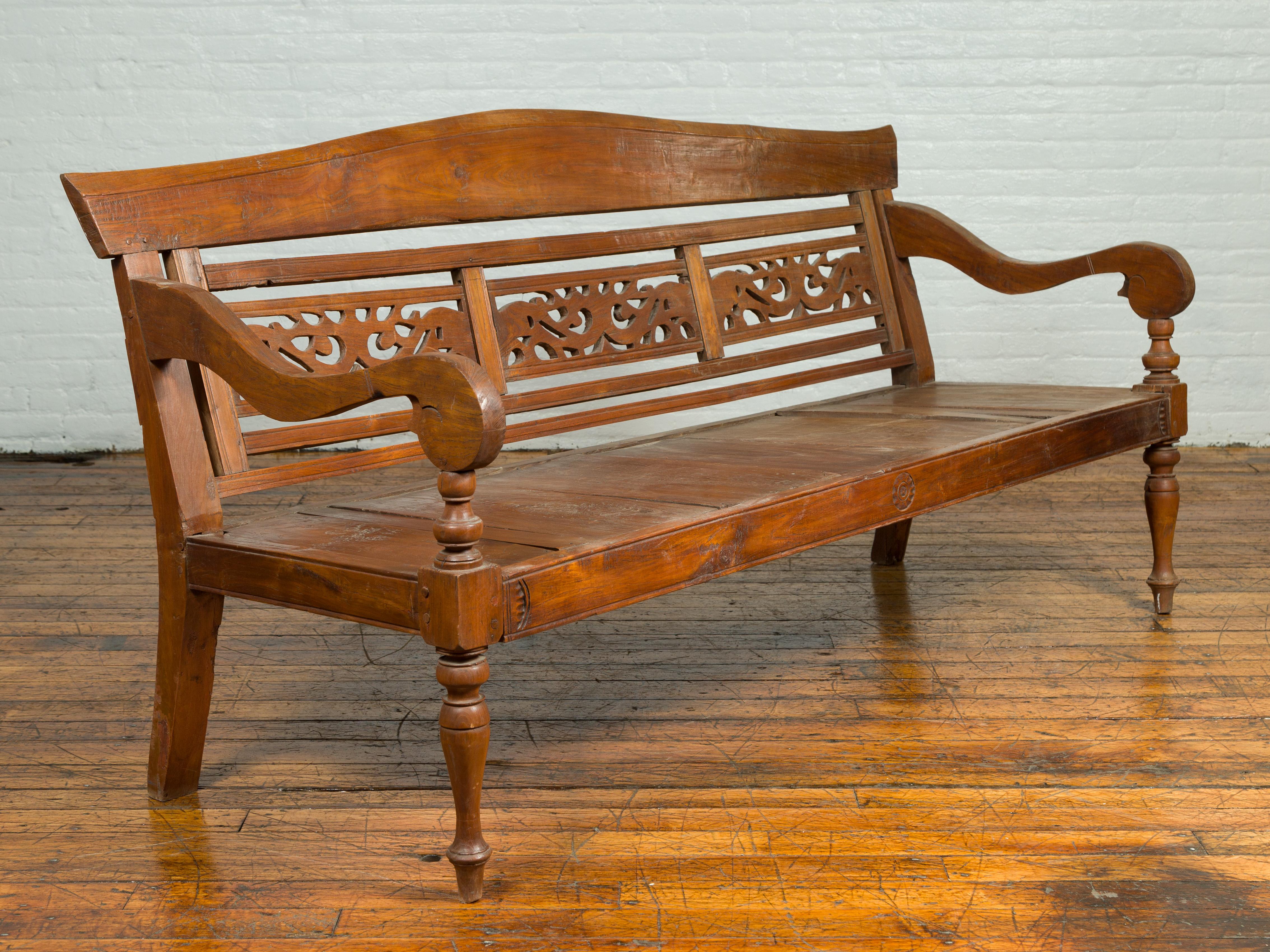 Indonesian Dutch Colonial Antique Wooden Bench with Carved Camelback and Scrolling Arms