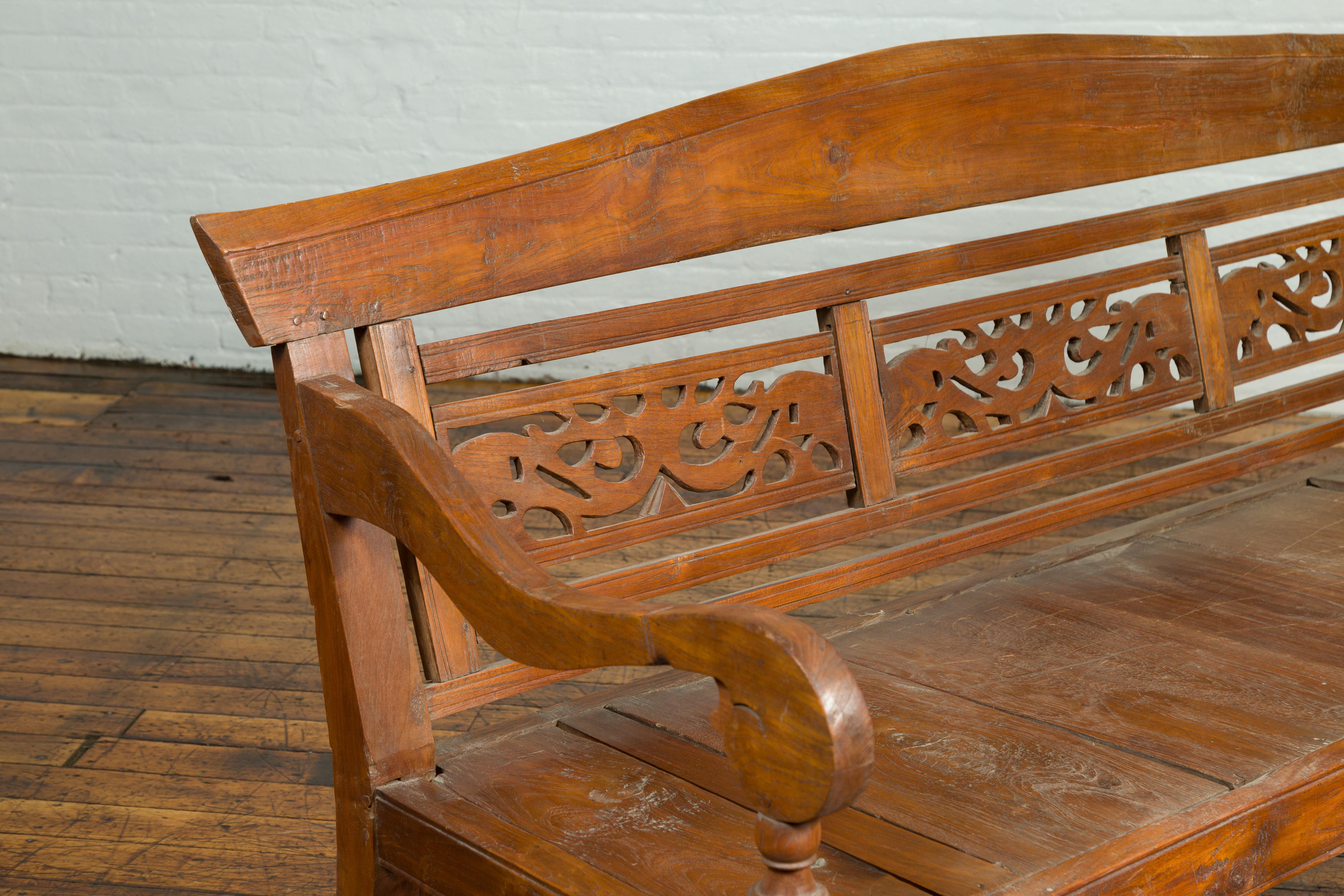 20th Century Dutch Colonial Antique Wooden Bench with Carved Camelback and Scrolling Arms