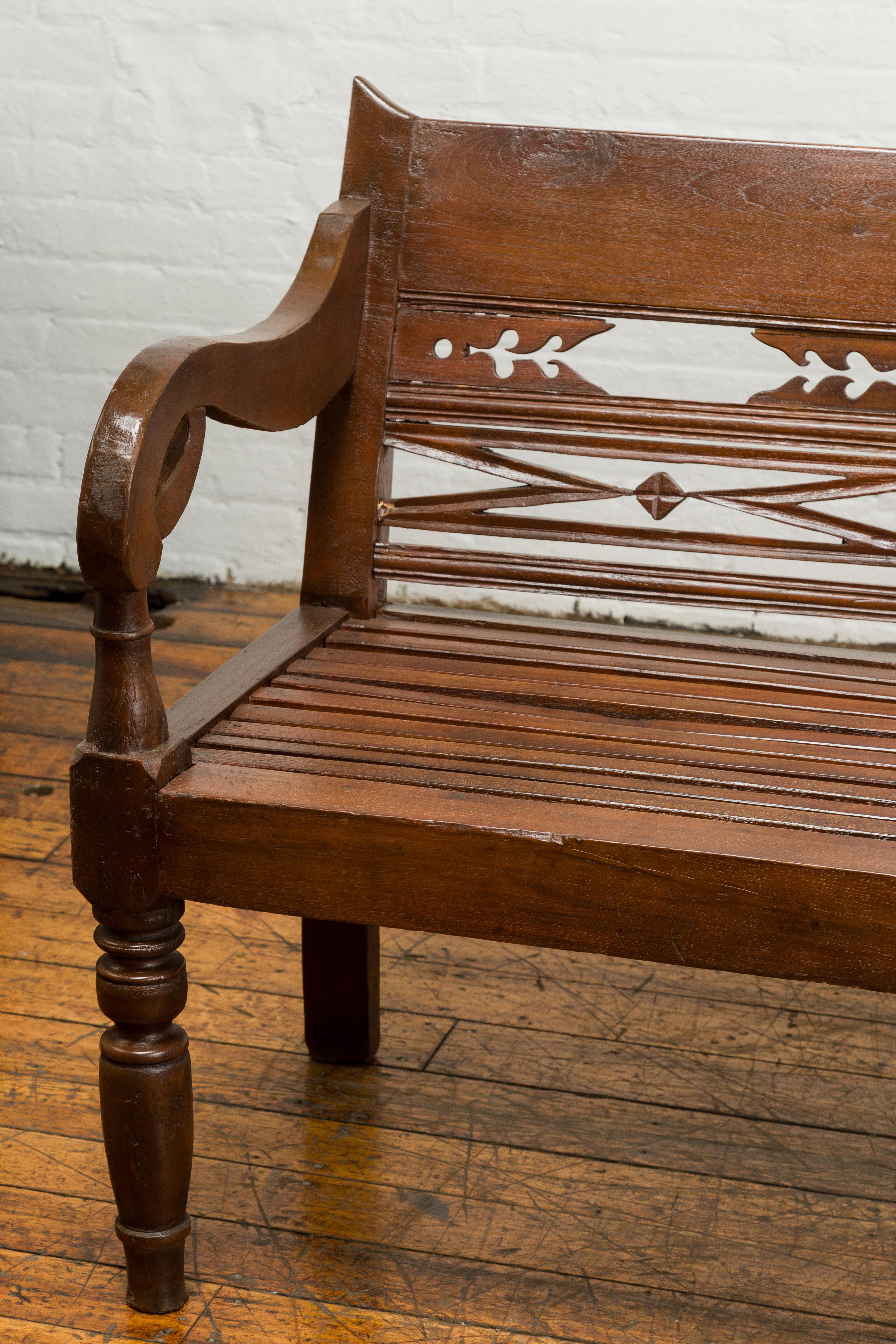 Wood Dutch Colonial Bench with Carved Back, Scrolling Arms and Turned Baluster Legs For Sale