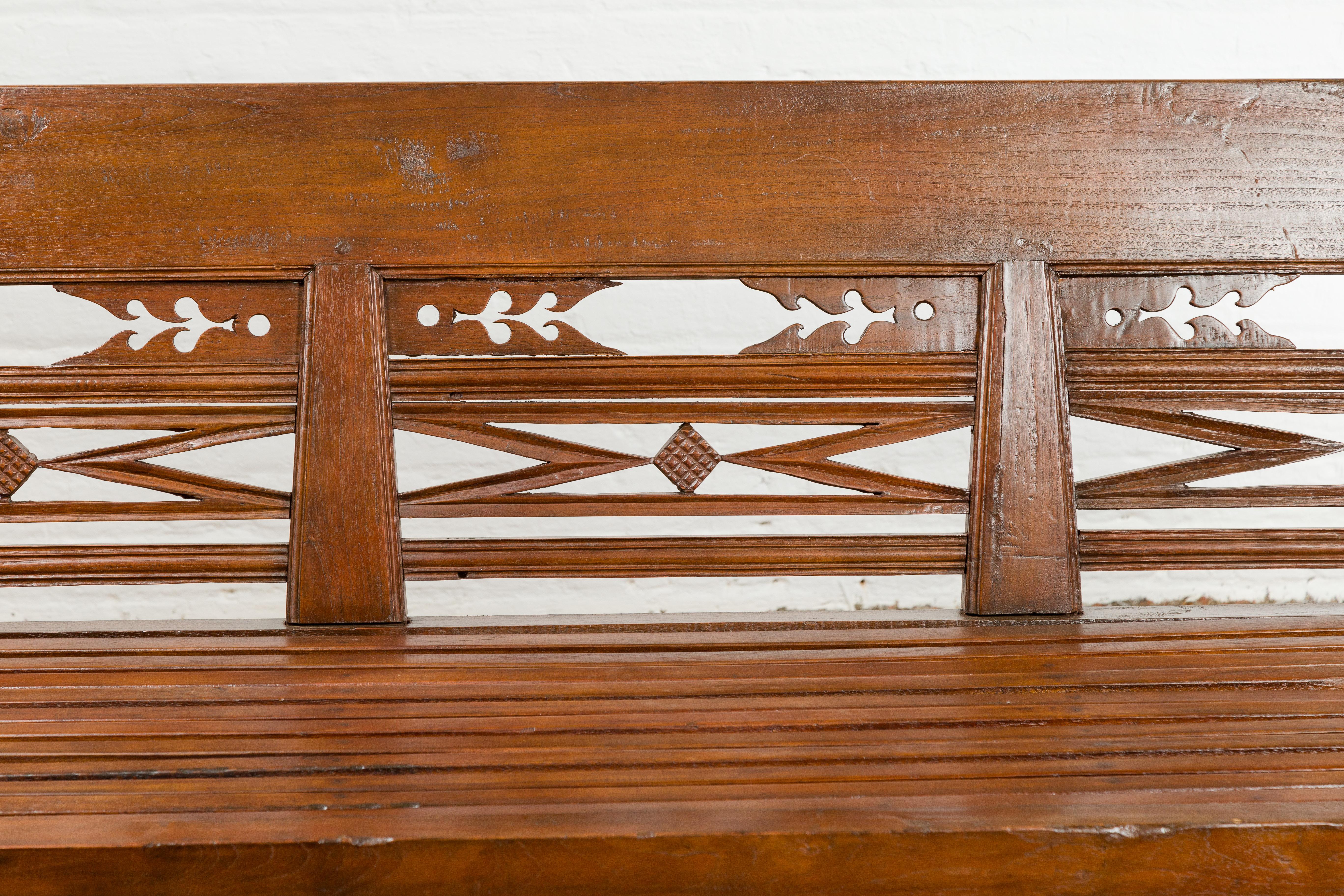 Dutch Colonial Bench with Carved Back, Scrolling Arms and Turned Baluster Legs For Sale 1