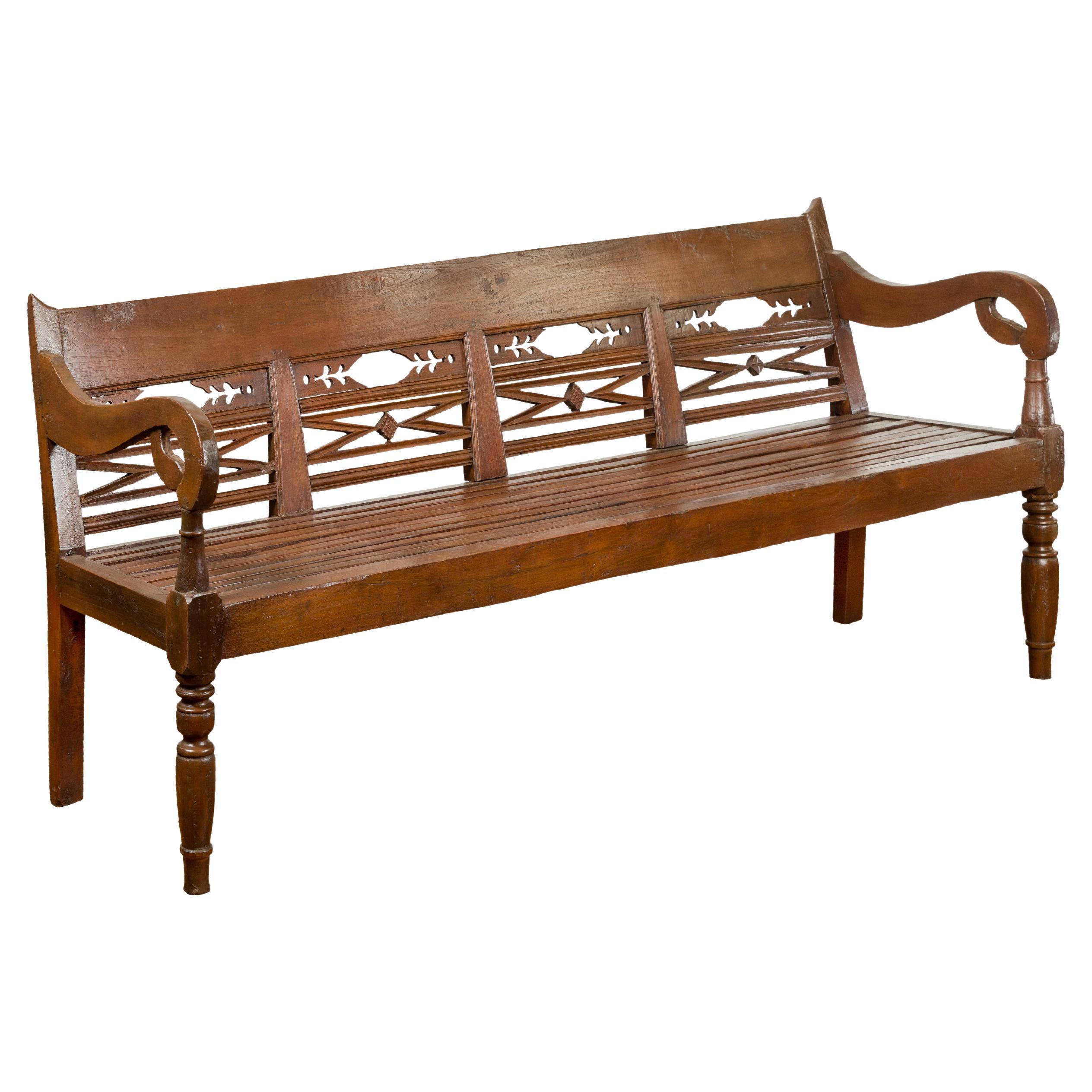 Dutch Colonial Bench with Carved Back, Scrolling Arms and Turned Baluster Legs For Sale