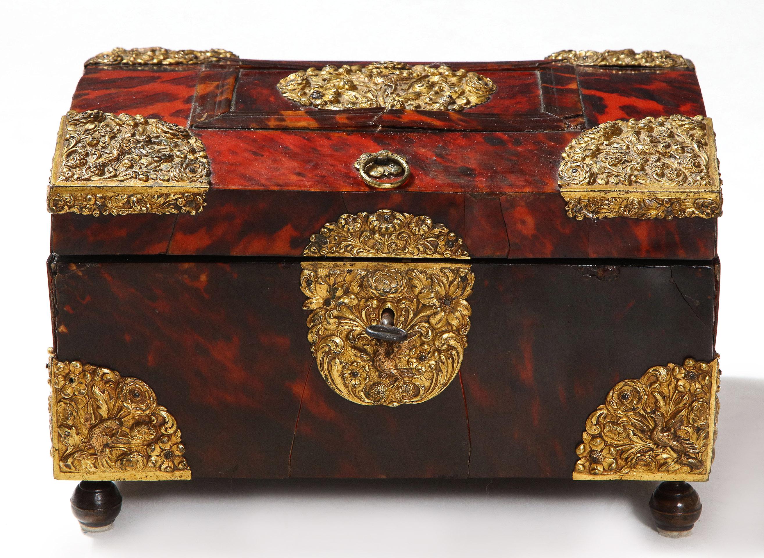 Of superb quality, this red tortoise shell box with beautifully executed gilded brass mounts was most likely originally made to hold Tea of Sirih. It is in very fine antique condition and comes with original lock and key.
