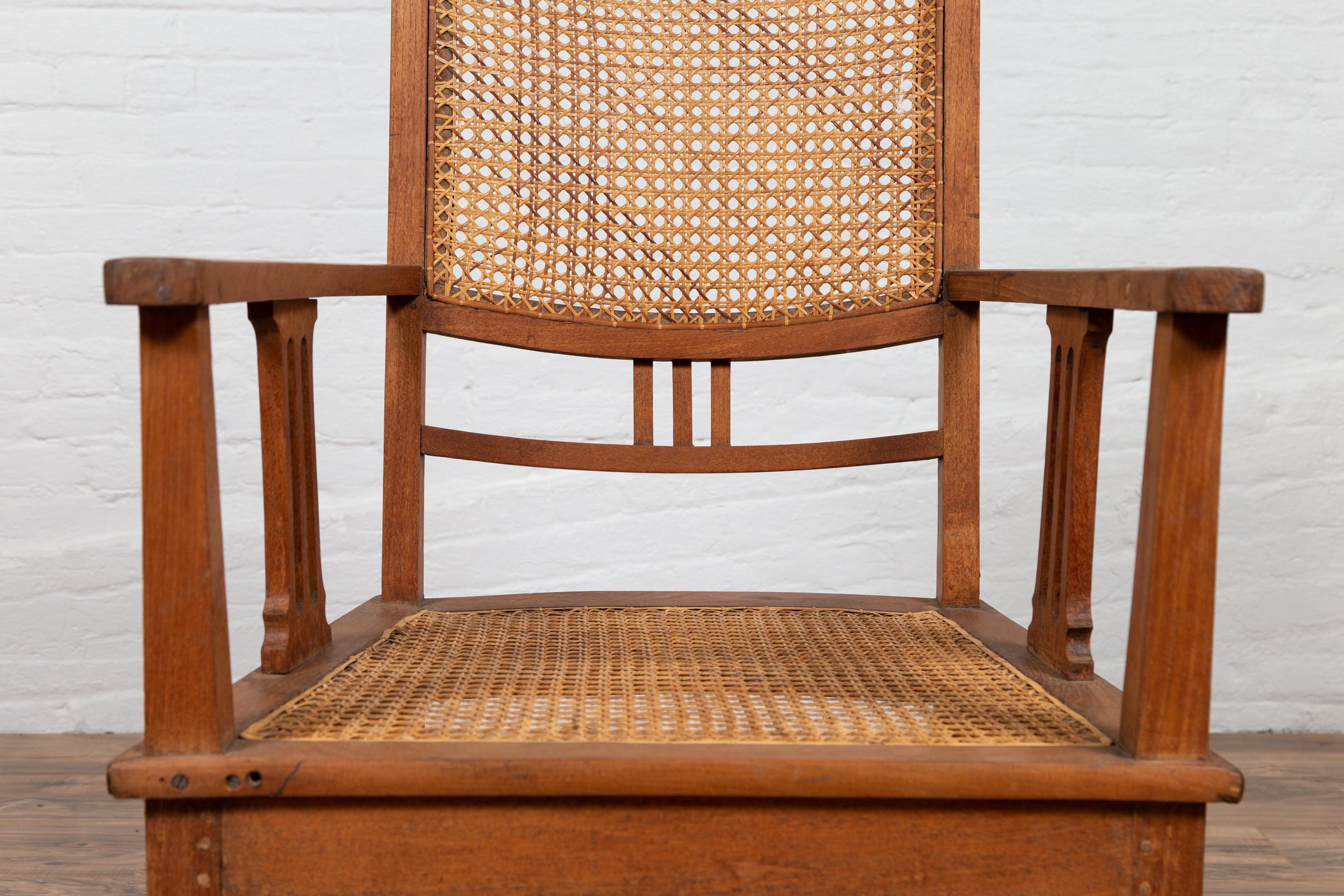 20th Century Dutch Colonial Javanese Teak Armchair with Rattan and Triglyph Inspired Motifs For Sale