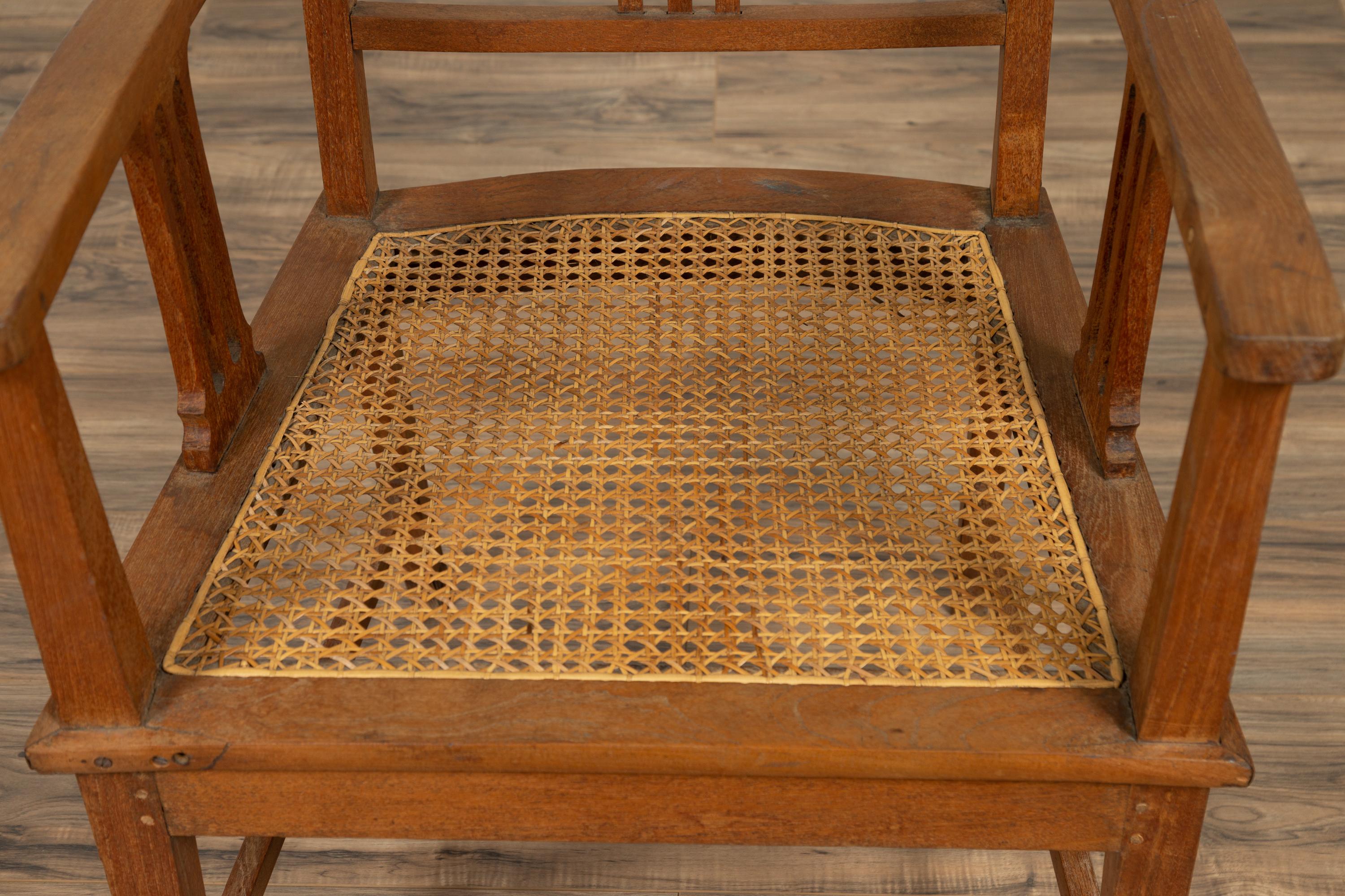 Dutch Colonial Javanese Teak Armchair with Rattan and Triglyph Inspired Motifs For Sale 1