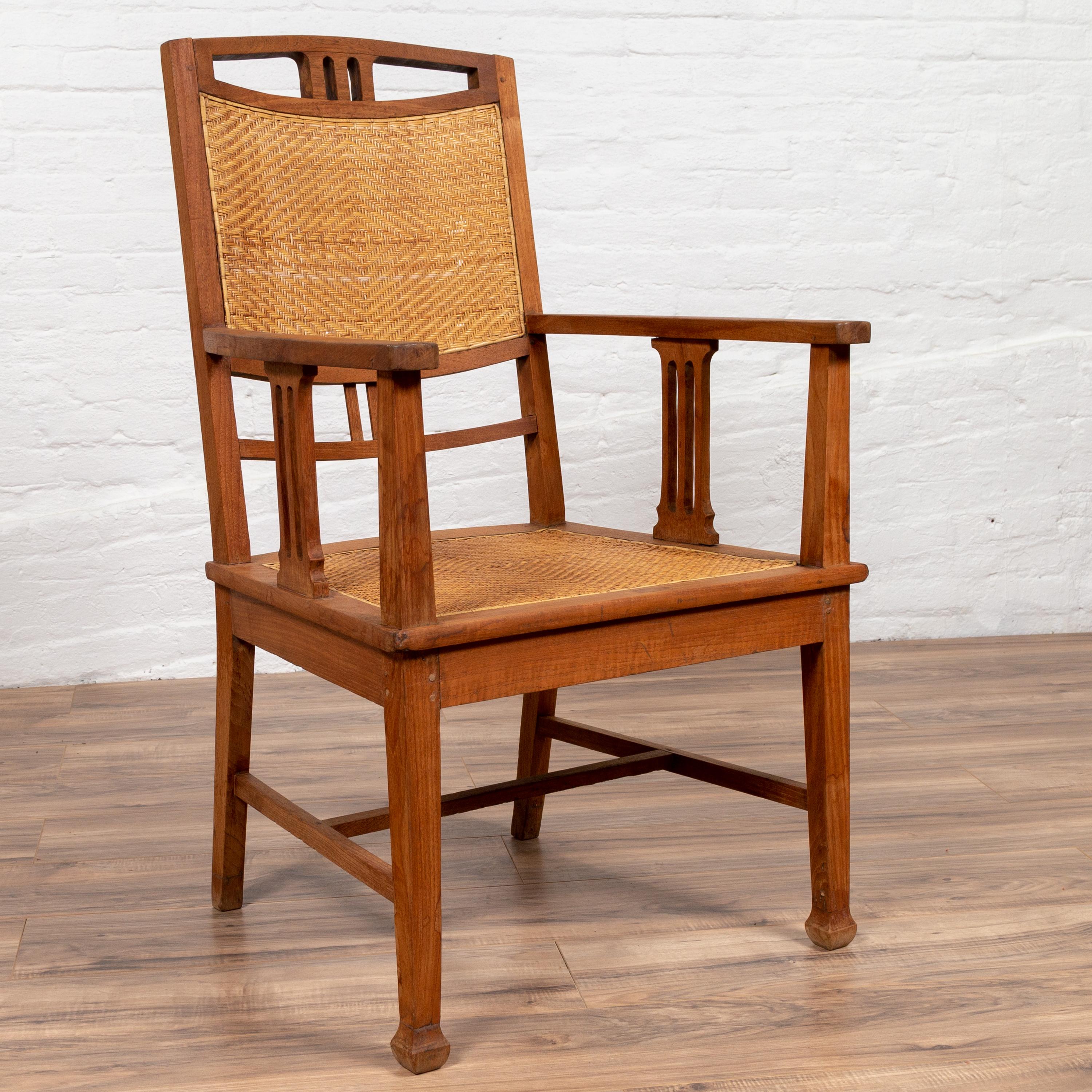 20th Century Dutch Colonial Javanese Teak Armchair with Rattan and Triglyph Inspired Motifs For Sale
