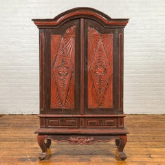 Dutch Colonial Late 19th Century Bonnet Top Cabinet with Carved Doors and Apron