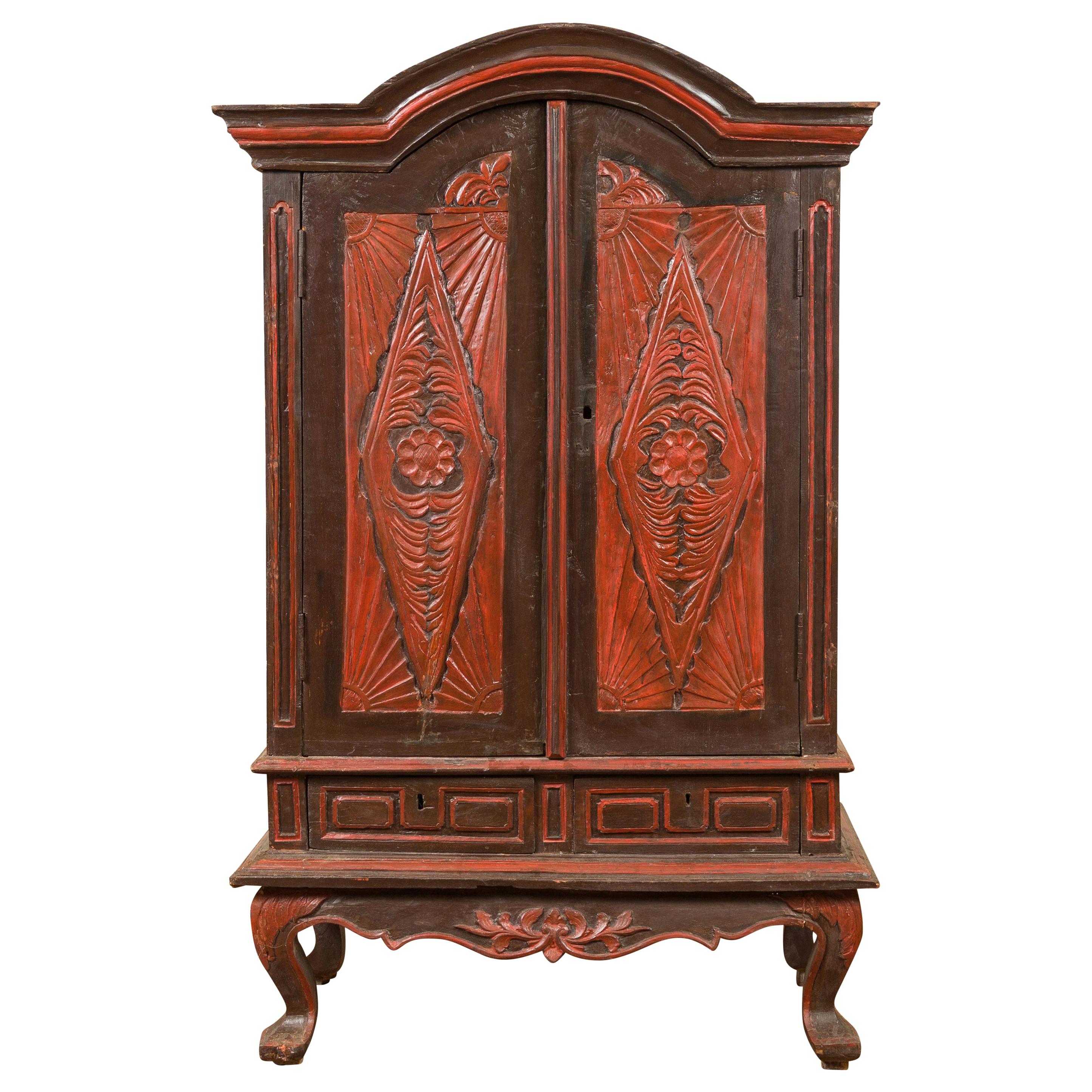 Dutch Colonial Late 19th Century Bonnet Top Cabinet with Carved Doors and Apron For Sale