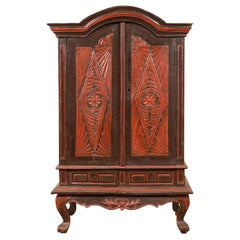 Dutch Colonial Late 19th Century Bonnet Top Cabinet with Carved Doors and Apron