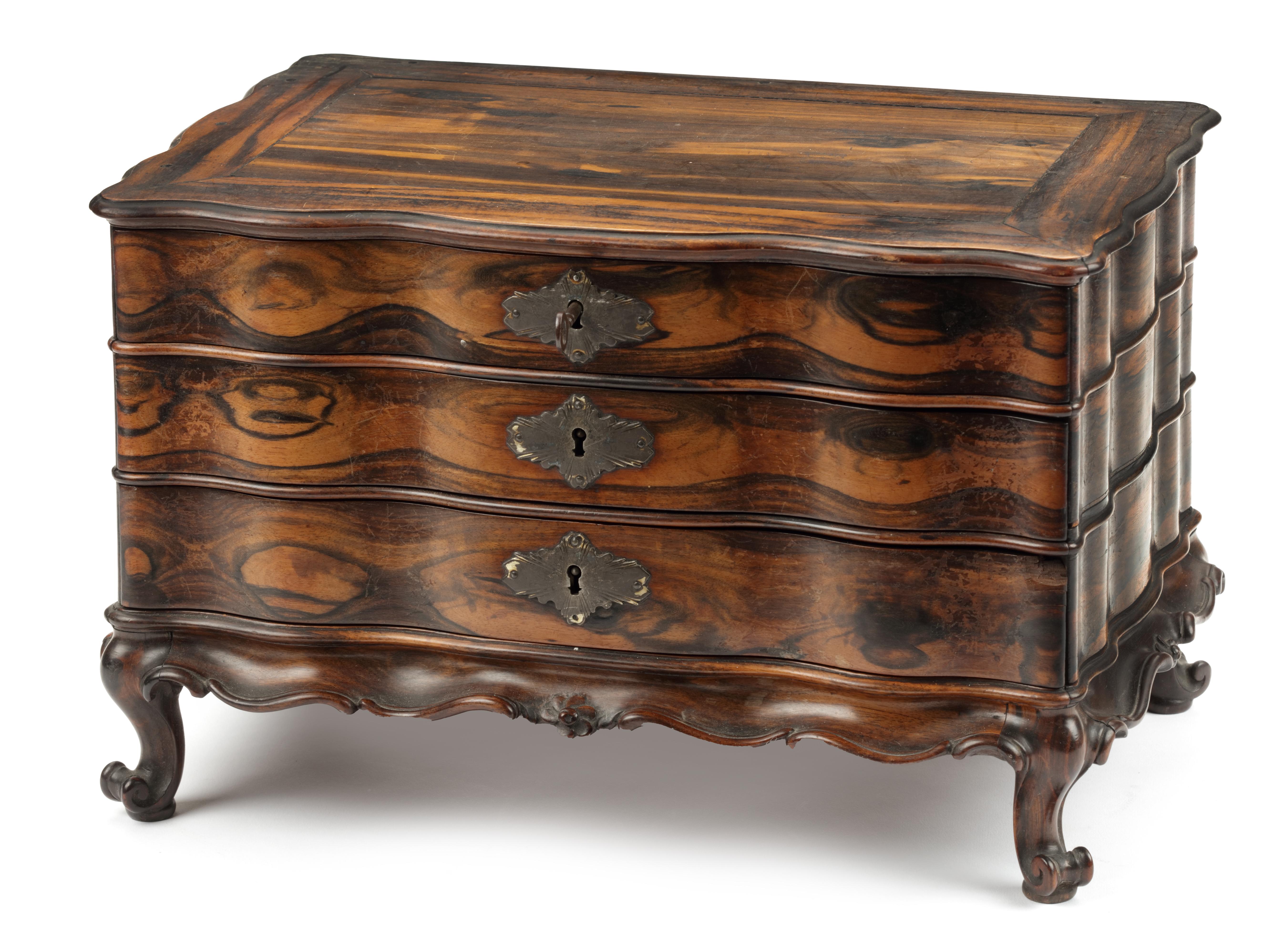 Miniature chest-of-drawers 

Sri Lanka, late 18th-early 19th century.

Calamander wood, Indian rosewood and palm wood, silver escutcheon, and English locks.

Measures: Height 23.3 cm., width 36.4 cm., depth 23.5 cm.

This chest-of-drawers