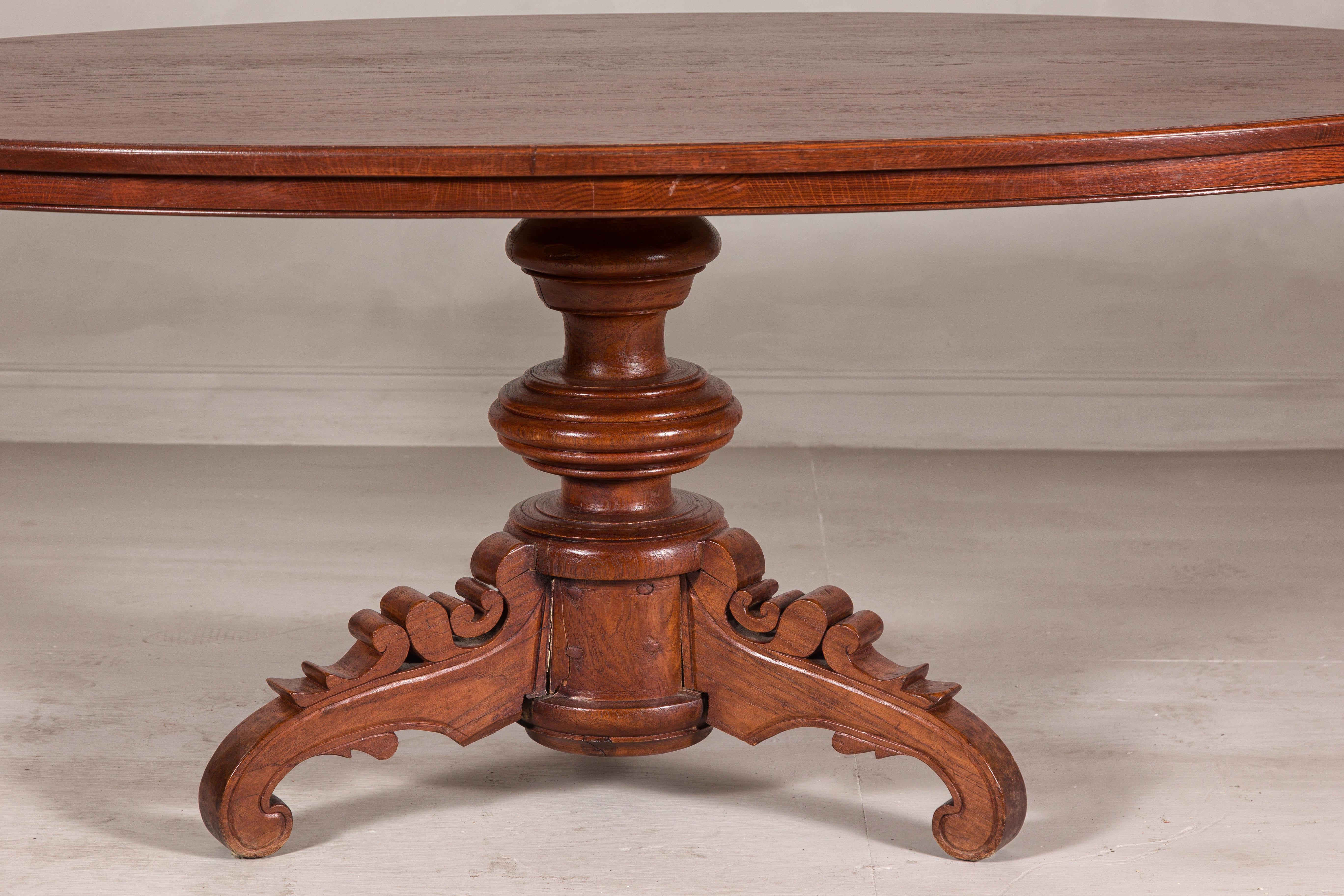 Dutch Colonial Oval Pedestal Dining Table with Scrolling Base, Late 19th Century For Sale 5