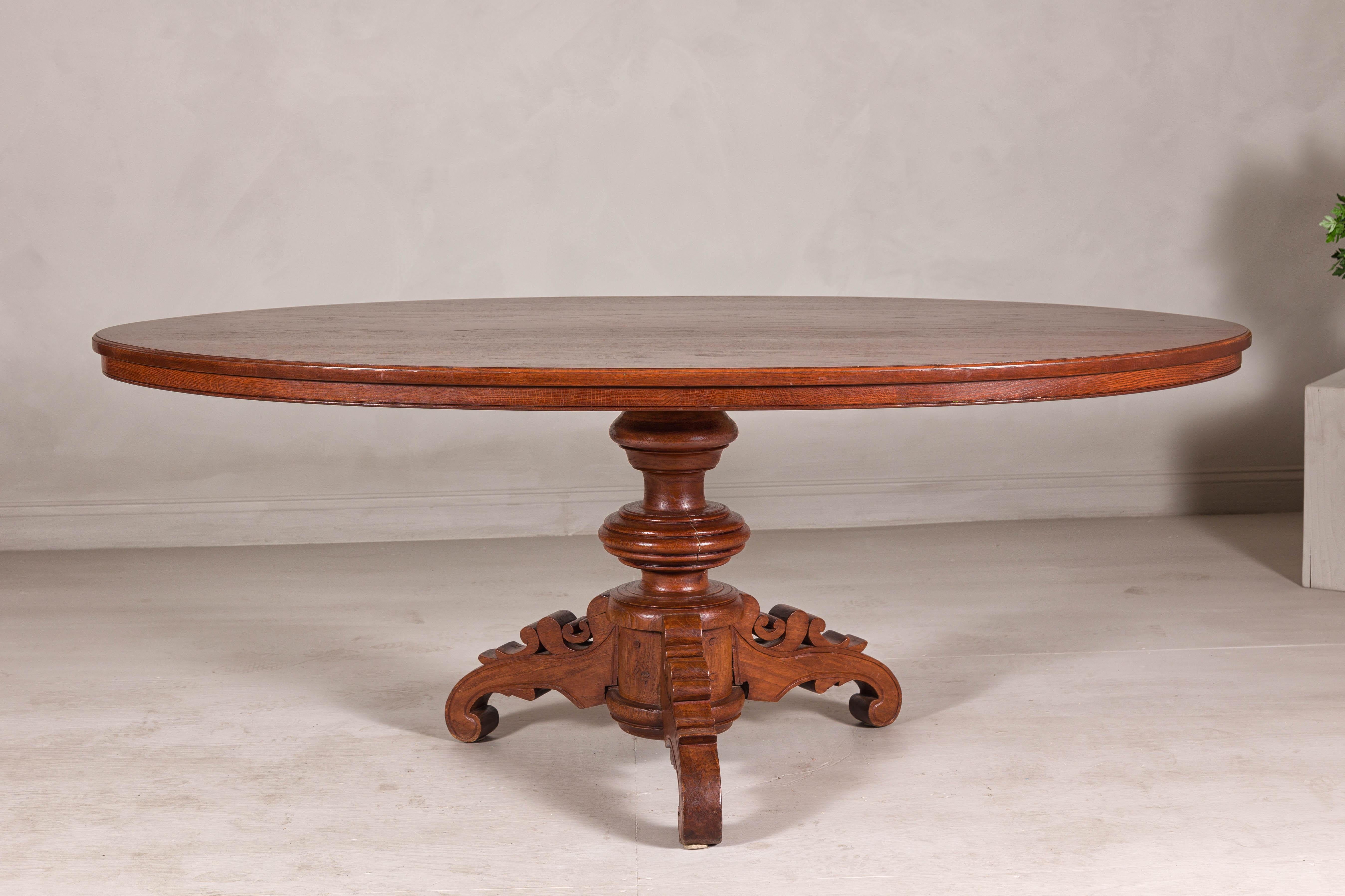 Dutch Colonial Oval Pedestal Dining Table with Scrolling Base, Late 19th Century In Good Condition For Sale In Yonkers, NY