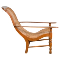 Antique Lounge Chair with Curved Seat and Extended Back