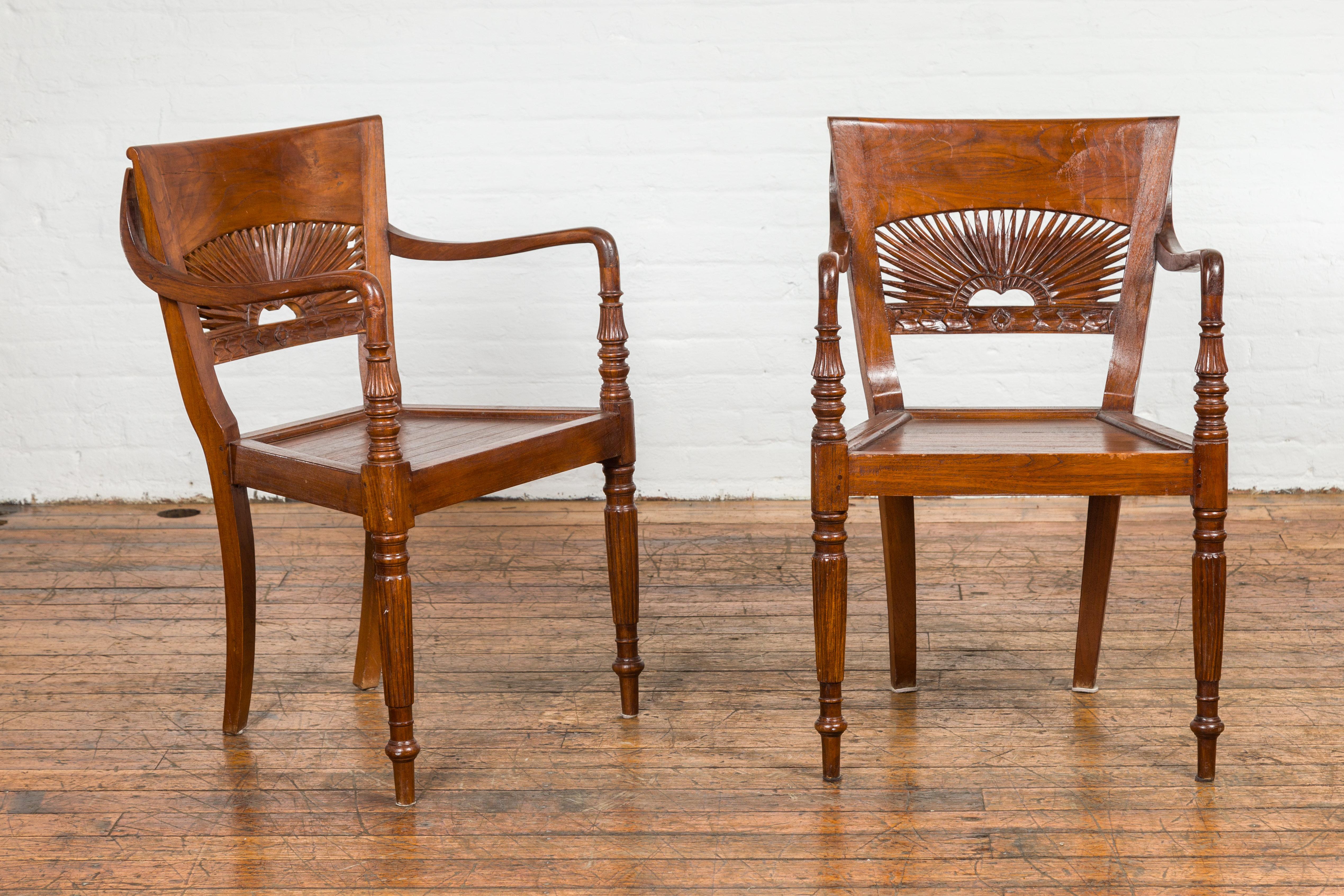 A set of six Dutch Colonial teak wood dining chairs from the 20th century with two arms and four sides. Dive into a rich tapestry of history with this set of six Dutch Colonial teak wood dining chairs from the 20th century. A harmonious blend of
