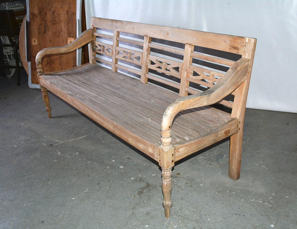 Colonial influenced hand carved rustic country daybed or bench made from natural teak, deep enough for sleeping or relaxing. Suitable for indoor or outdoor use. Great on a porch or patio. Bench has decorative hand carved details on the back, slatted