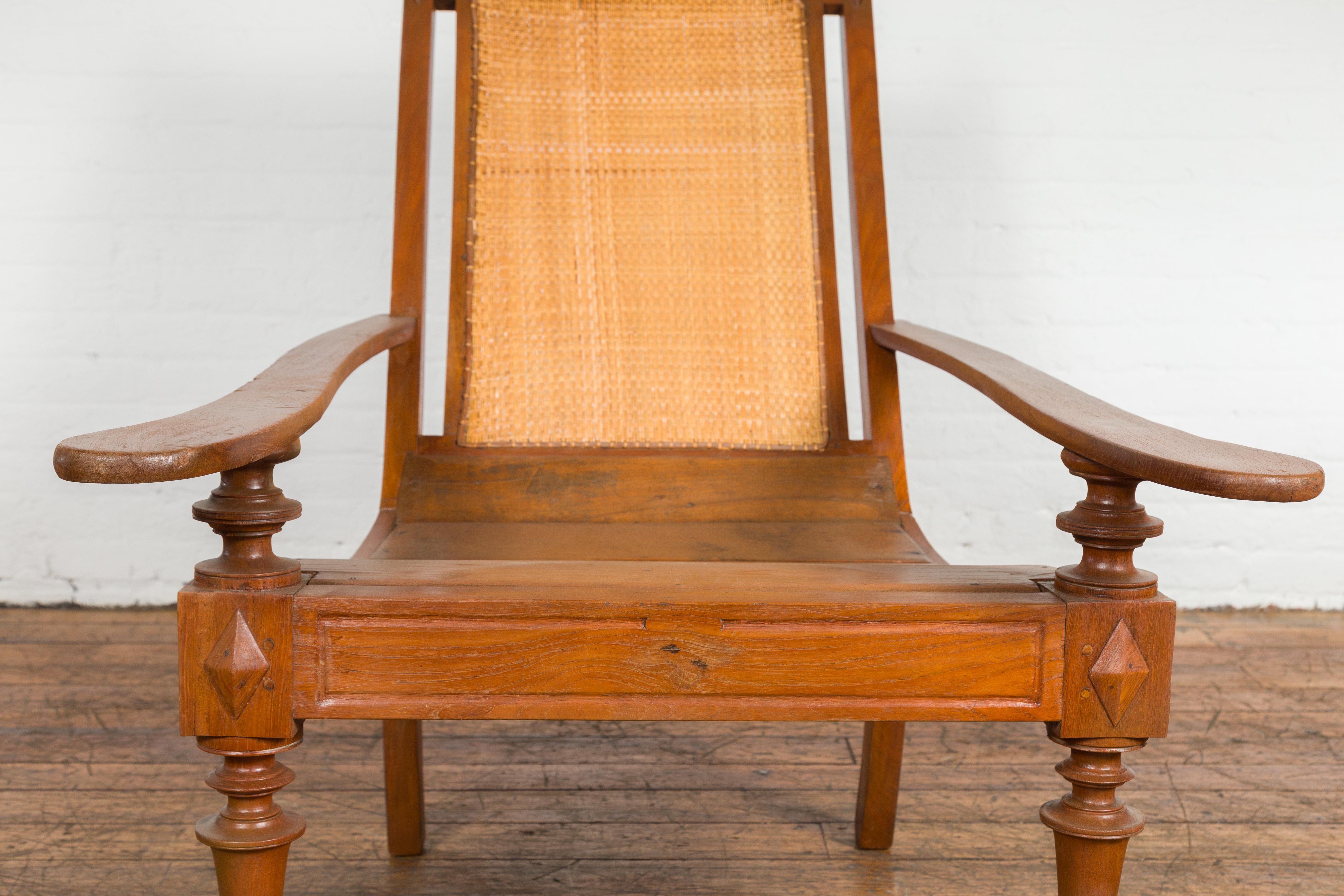 Dutch Colonial Wood and Rattan Lounge Chair with Slanted Back and Carved Finials For Sale 3