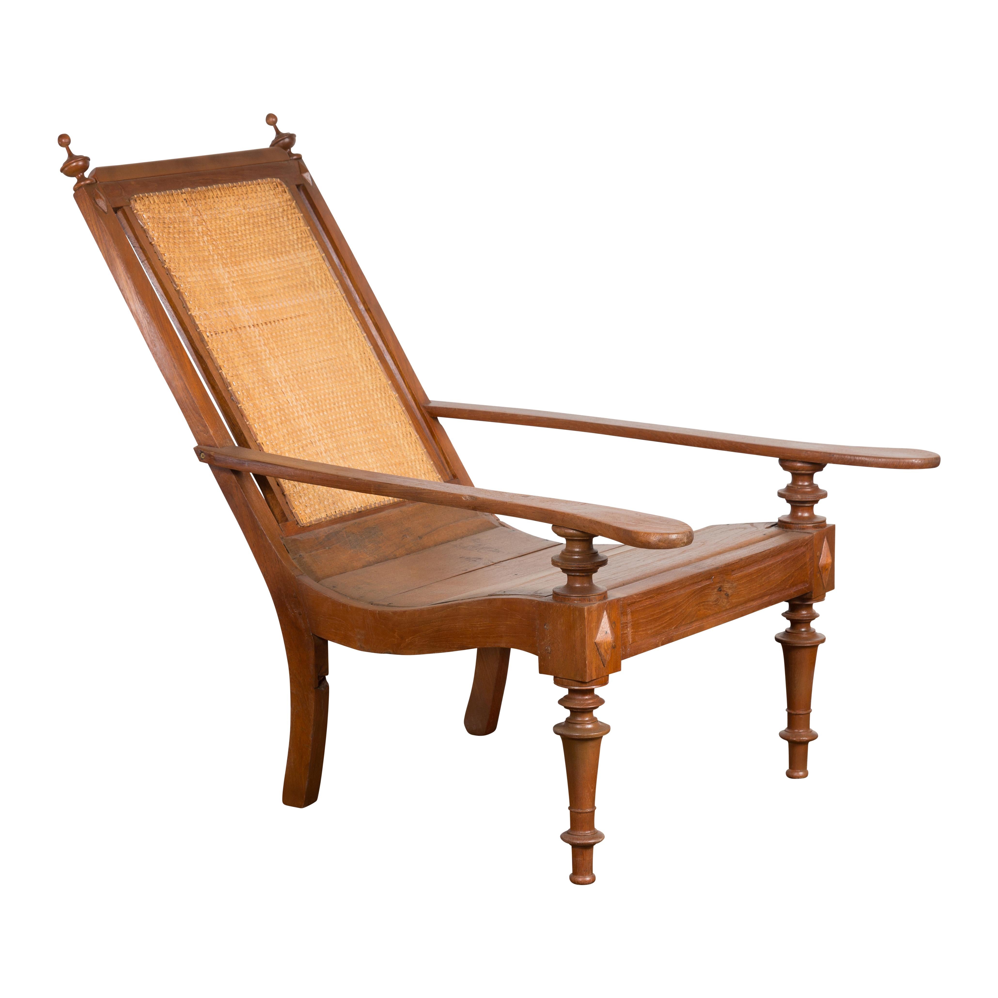Dutch Colonial Wood and Rattan Lounge Chair with Slanted Back and Carved Finials For Sale 8