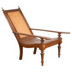 Antique Dutch Colonial Wood and Rattan Lounge Chair with Slanted Back and Carved Finials