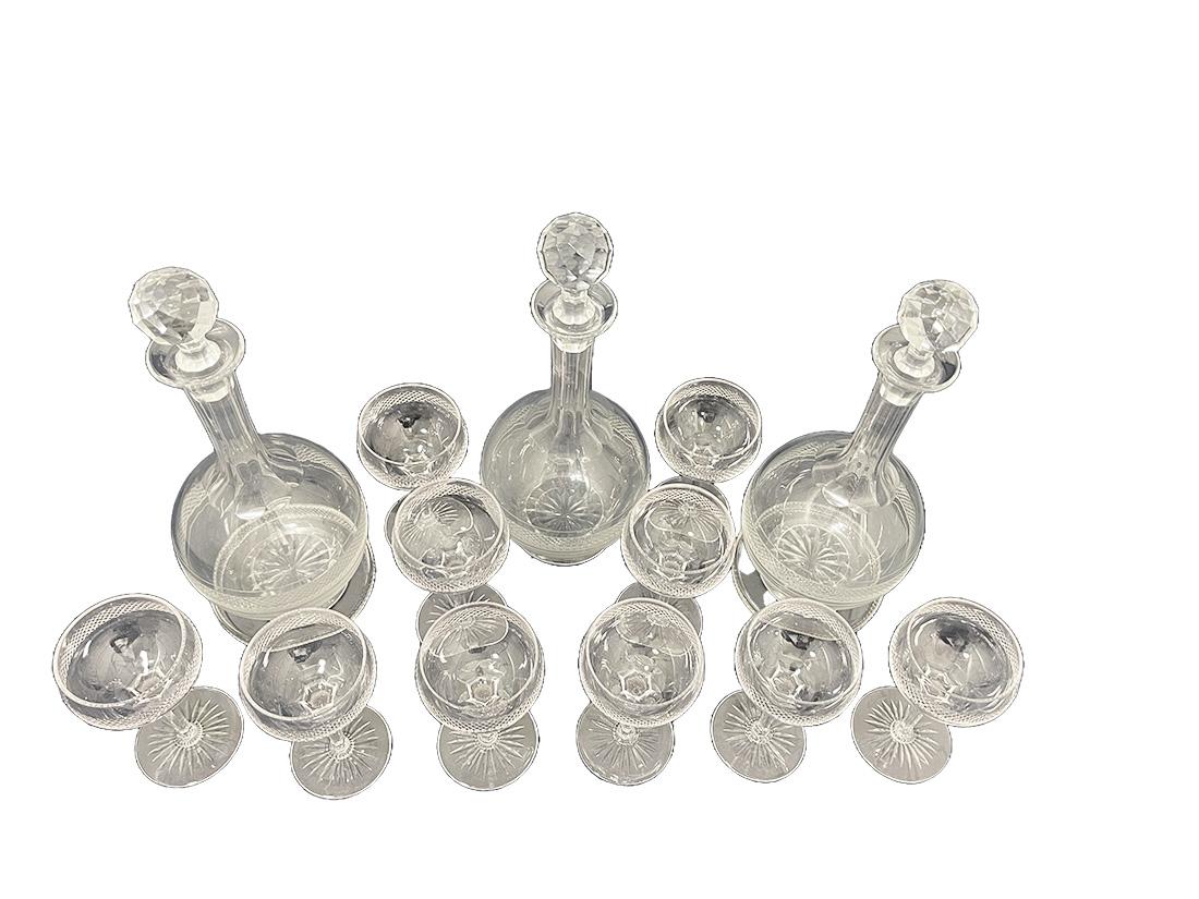 Dutch crystal liqueur set, ca 1890

The set crystal liqueur set consists of 3 decanters, raised on a round foot with facet crystal cut shape of a star in the bottom. A round belly that tapers upwards with an 8-sided facet cut long neck. Each carafe