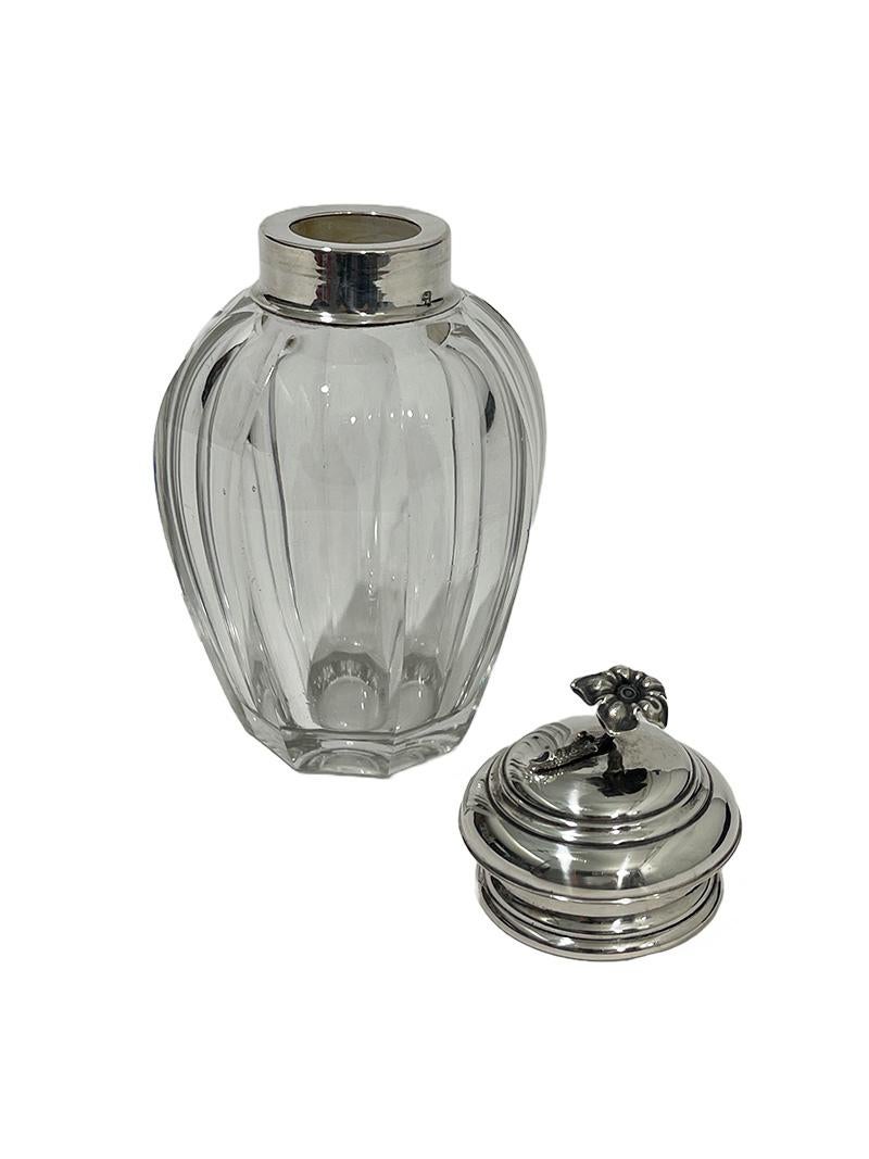 Dutch Crystal Tea Caddy with Silver cap, by Van Kempen & Zn, 1862

A Dutch octagonal crystal tea caddy with silver cap. A beautiful flower on top of the cap. The tea caddy is made by Fa. J.M. Van Kempen & Zonen, Voorschoten in 1862. The silver has