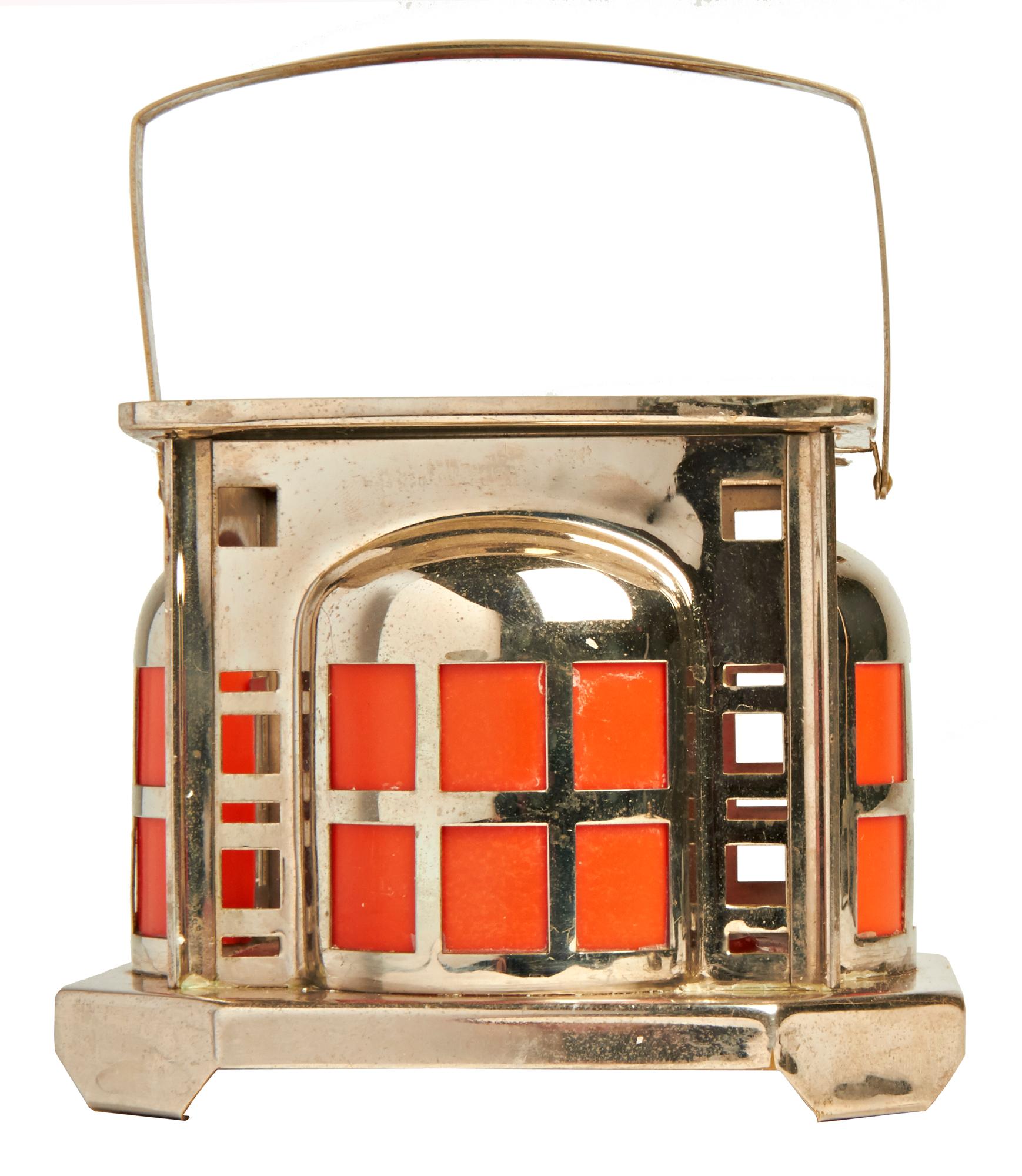 This Dutch De Stijl nickel plated and orange Bakelite oil lamp/table warmer is the square version of these iconic designs of Dutch company, Daalerdrop Tiel. The square housing is in amazing condition and features four sheets of orange Bakelite