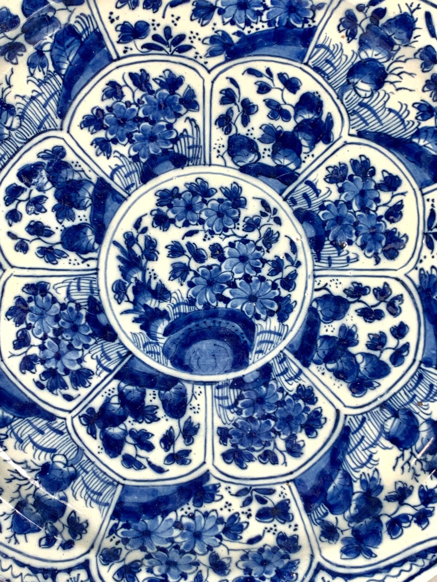 This large Dutch Delft charger was hand-painted at the De Witte Starre* factory in Haarlem circa 1770.
The cobalt blue decoration is arranged in petal-like panels radiating from a central roundel.
Each panel is filled with abundant hand-painted
