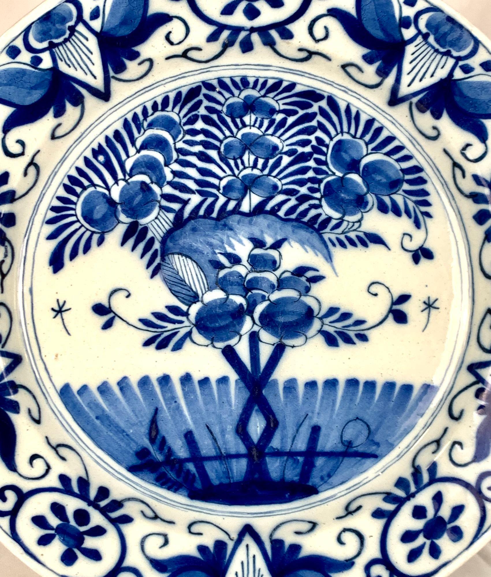 This lovely blue and white Delft charger was made in the Netherlands around 1780.
It was meticulously hand-painted in two shades of cobalt blue on a white tin-glazed surface.
The center of the charger portrays a beautiful garden scene, with a