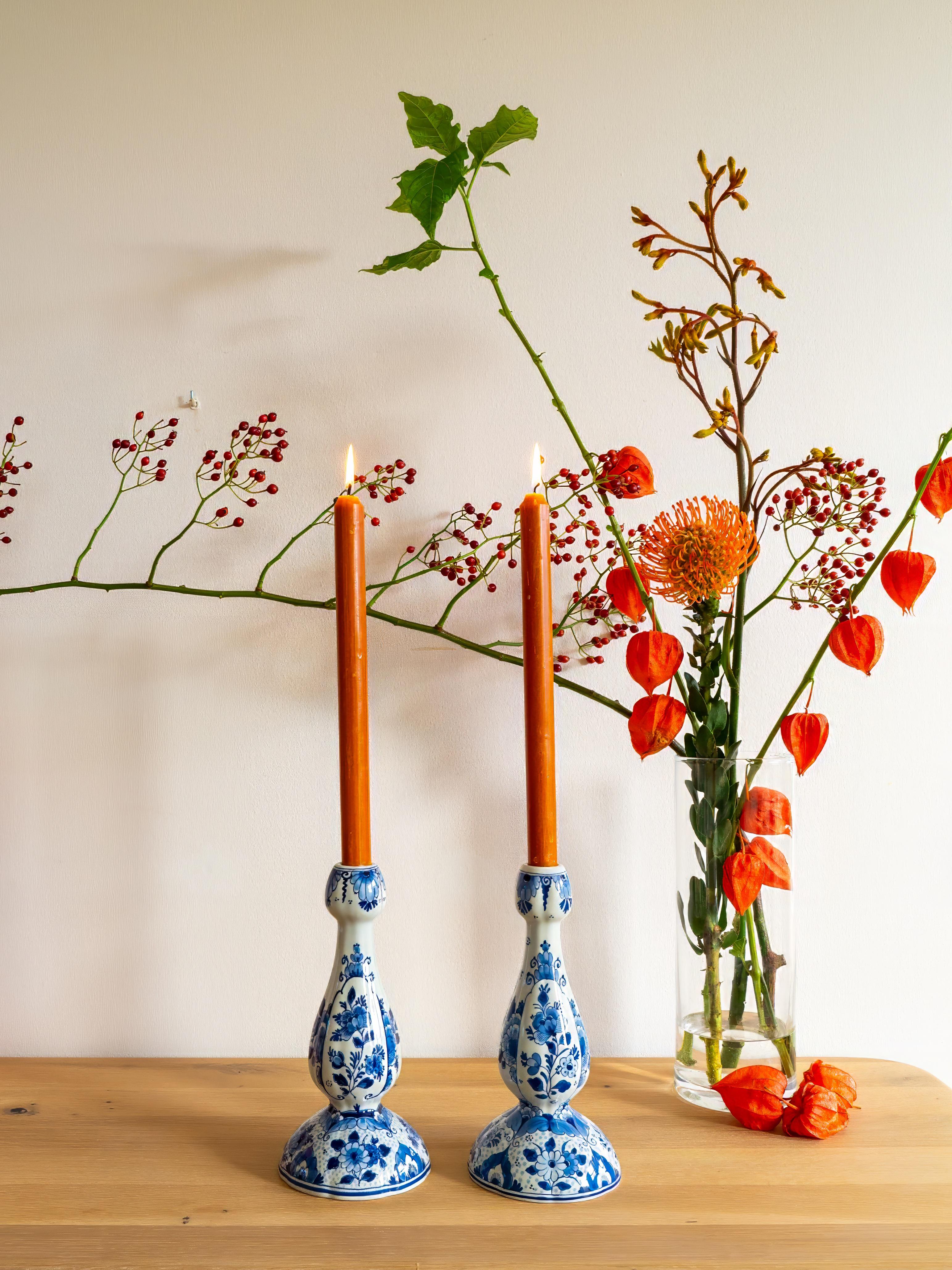 This elegant pair of tulip-shaped candlesticks was handcrafted by Royal Delft (De Porceleyne Fles), the oldest surviving Delftware factory, established in 1653. Known for its exquisite hand-painted Delft Blue ceramics, Royal Delft continues to
