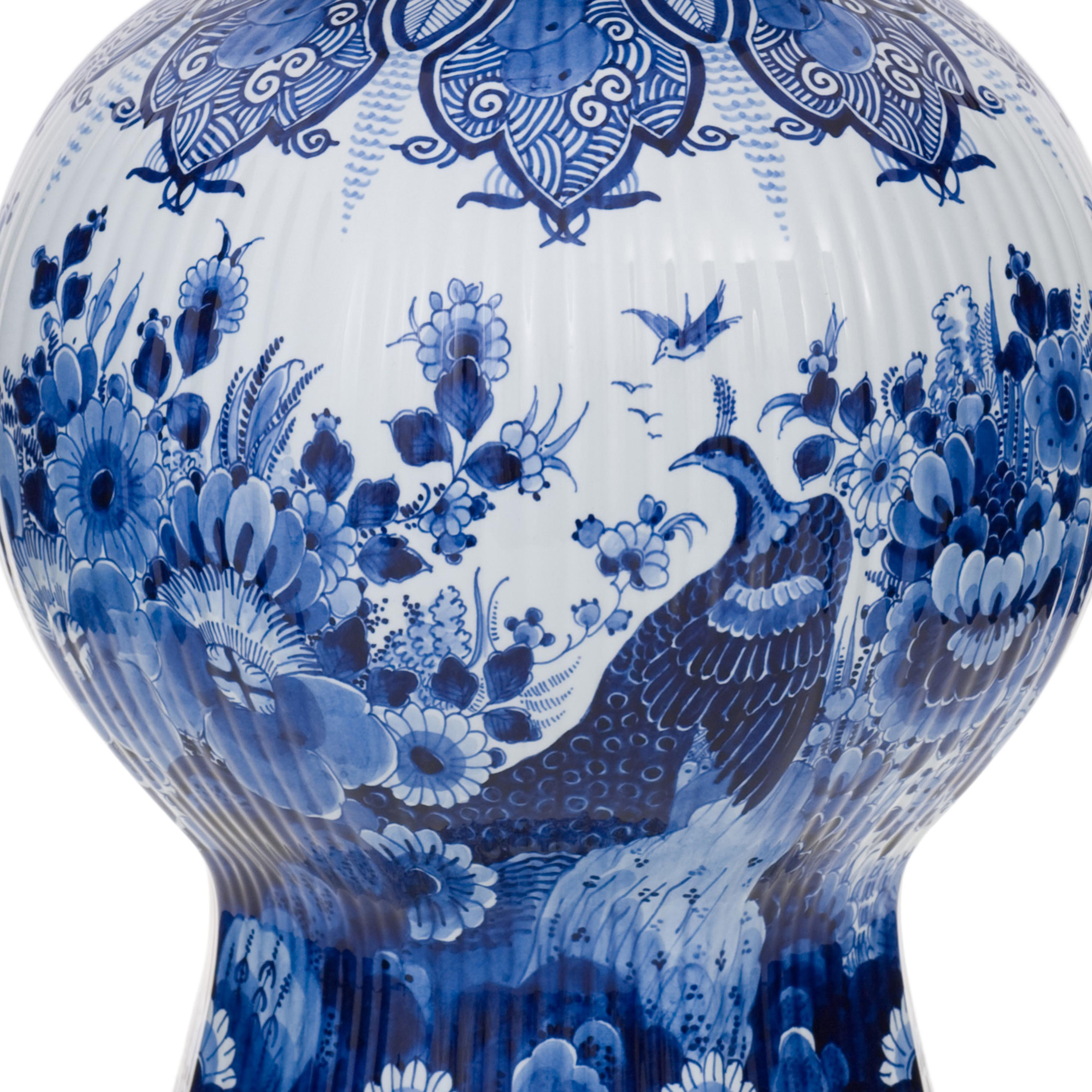 This hand-painted Delft Blue jar is part of a cabinet set. In the thirties of the eighteenth century no fewer than ten types were launched in Delft. According to the fashion of that time, cupboards were placed on the overhanging hood of a cabinet.