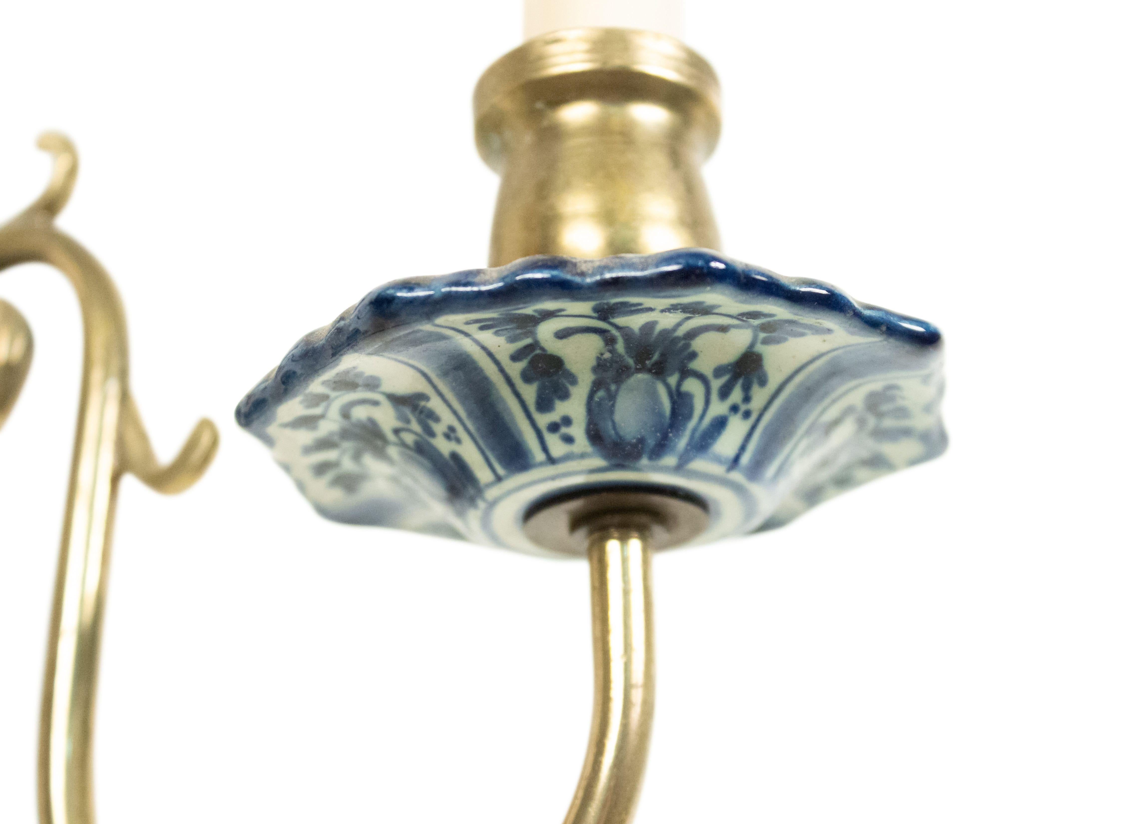 Dutch Delft (20th Century) blue and white porcelain and brass wall sconce with two arms.
  