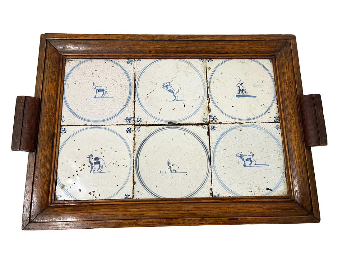Dutch Delft blue tiles serving tray, 1650-1700

A serving tray in oak wood with Dutch Delft blue tiles, 1650-1700. The tiles with scene of animal in blue lined circle. The most unusual tile is the Delft blue tile with a camel. The 