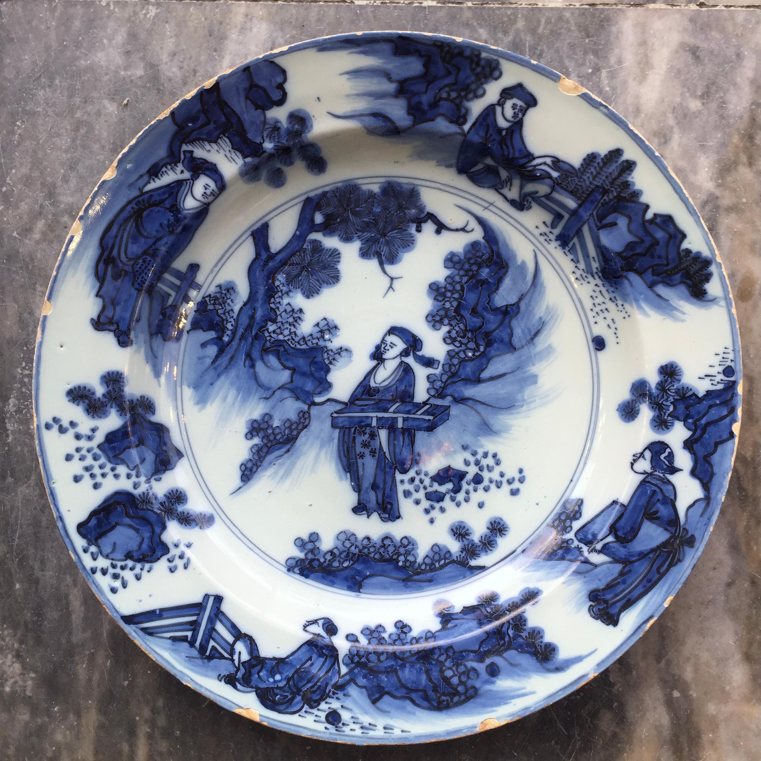 City: Delft
Workshop: Unknown
Date: Last quarter of the 17th century

A large blue and white Dutch Delft Charger with a decoration in the Chinese Transitional style.
On the Decoration is the center we see a Chinese official, in a landscape, bearing
