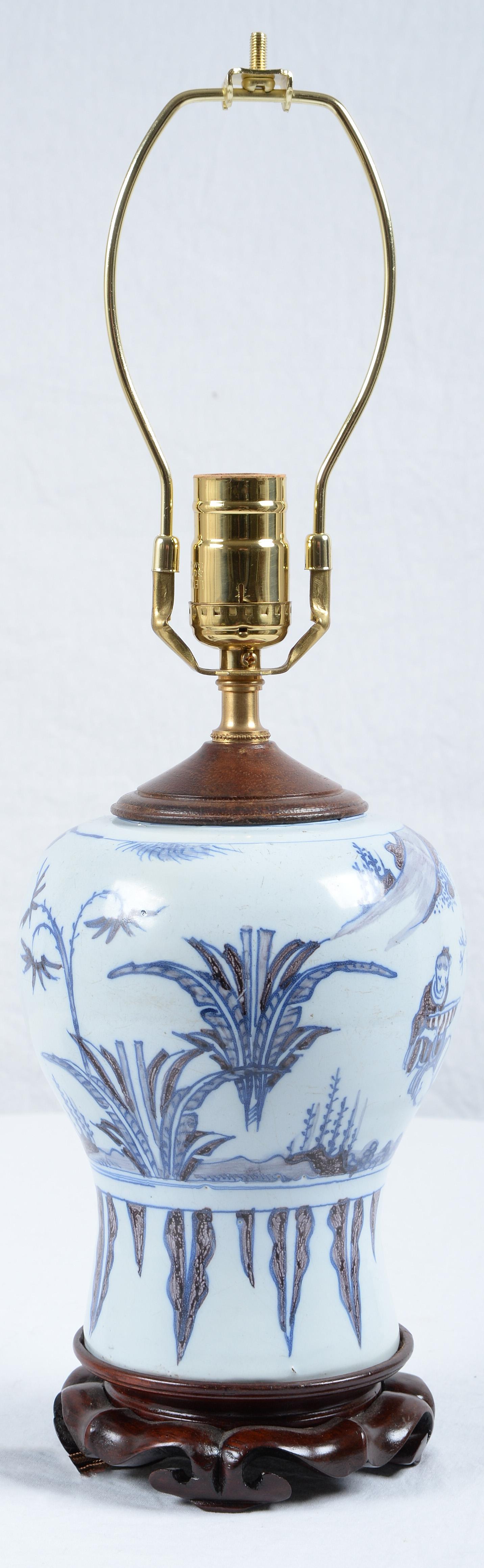 Late 17th Century Dutch Delft Faience Blue and White Chinoiserie Baluster Vase Mounted as a Lamp and newly electrified.
Decorated in imitation of a Chinese Ming vase with a sage, rocks and vegetation, mounted on a wood base. 
The dimensions noted