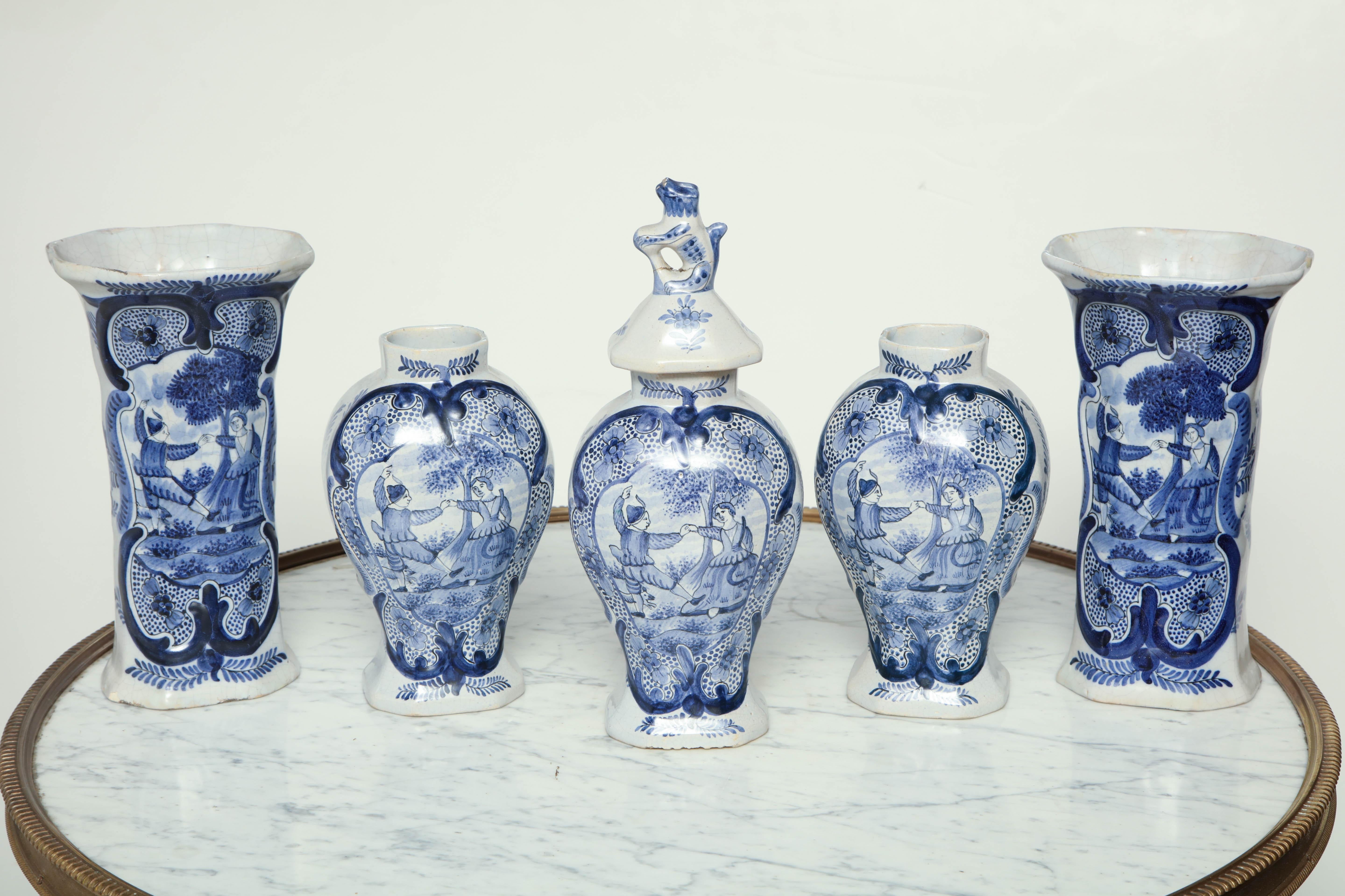 A five piece 18th century Dutch Delft blue and white garniture set consisting if two vases and three jars, one with lid.