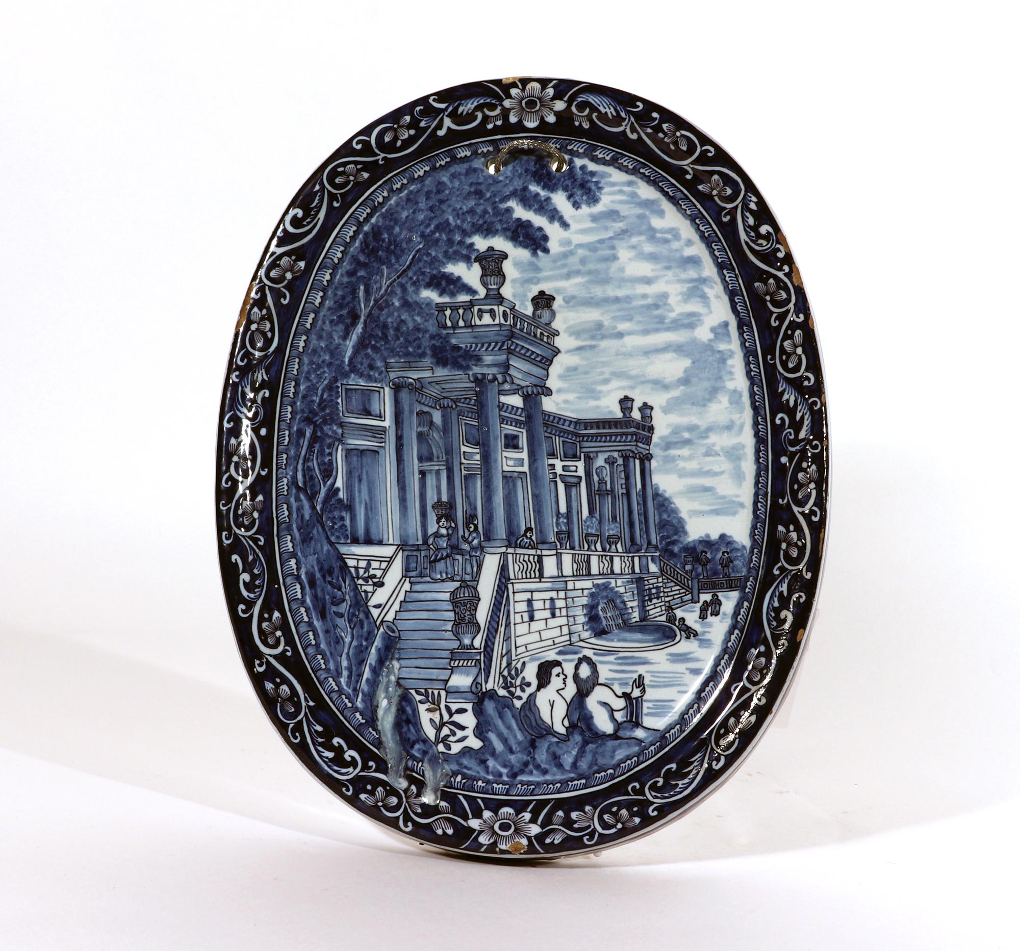 Dutch Delft Oval Blue & White Plaque,
Pieter Gerritsz Kam, (The Three Porcelain Ash-Barrels) factory), or his widow Maria van der Kloot,
Circa 1700-1710

The large Dutch Delft blue and white plaque in an upright format is painted with the facade of