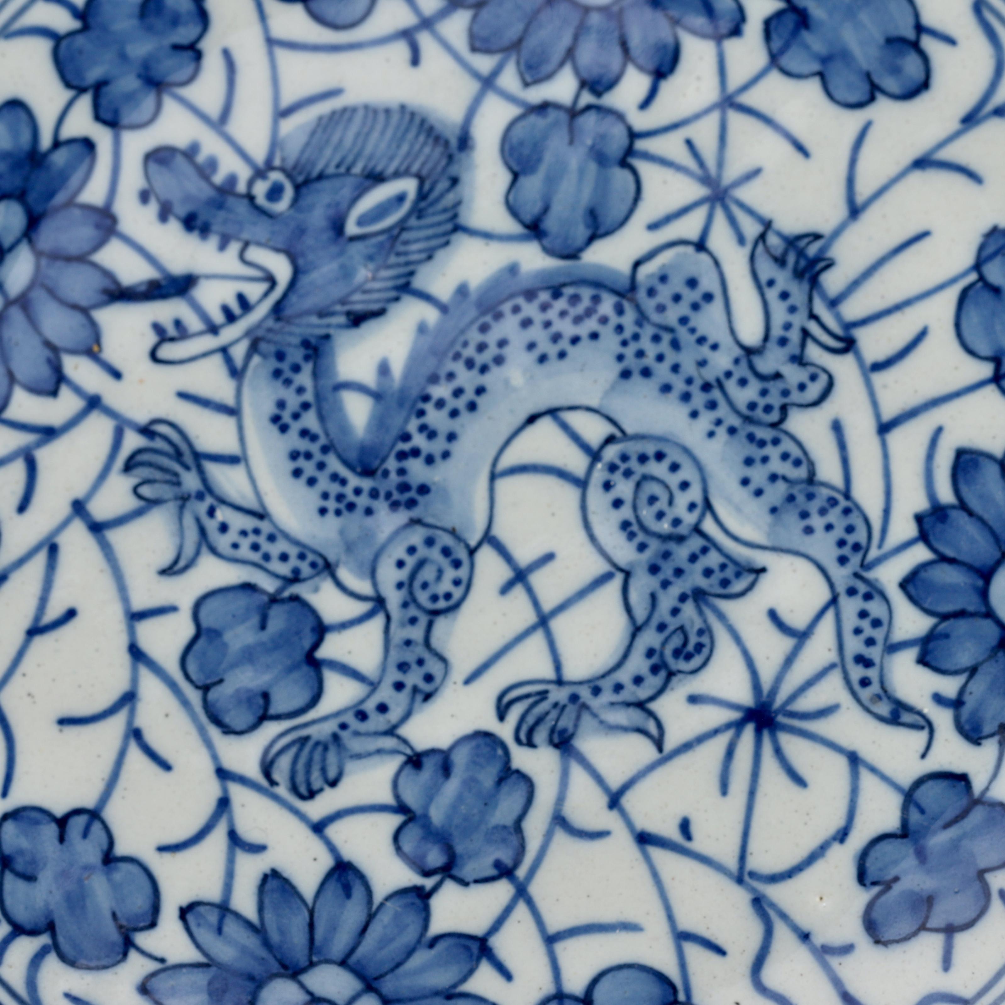 City: Delft
Workshop: De Grieksche A
Owner: Jacob van der Kool
Date: 1722 - 1757

Plate with decoration of a dragon on a ground of vines.
Wonderful fine decoration inspired on the Chinese Kangxi porcelain.
De rim is decorated with five