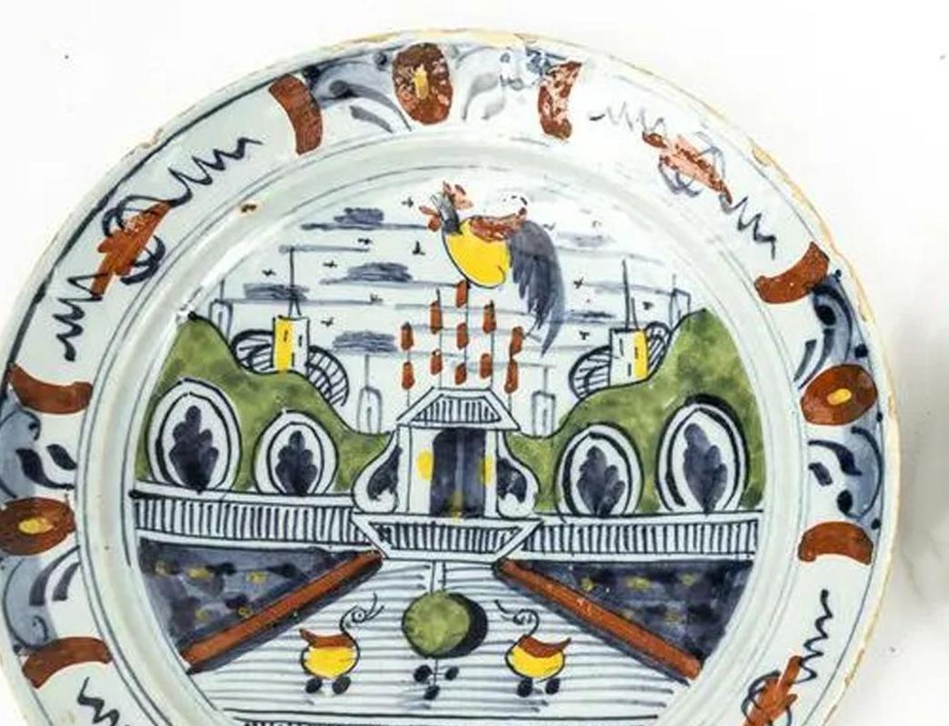 Dutch Delft polychrome plate with garden scene,
Circa 1765.

The Dutch Delft pancake plate is unusually painted with a garden scene with a stylized ornamental pool with a yellow and red duck on either side,

Dimensions: 8 3/4 inch diameter