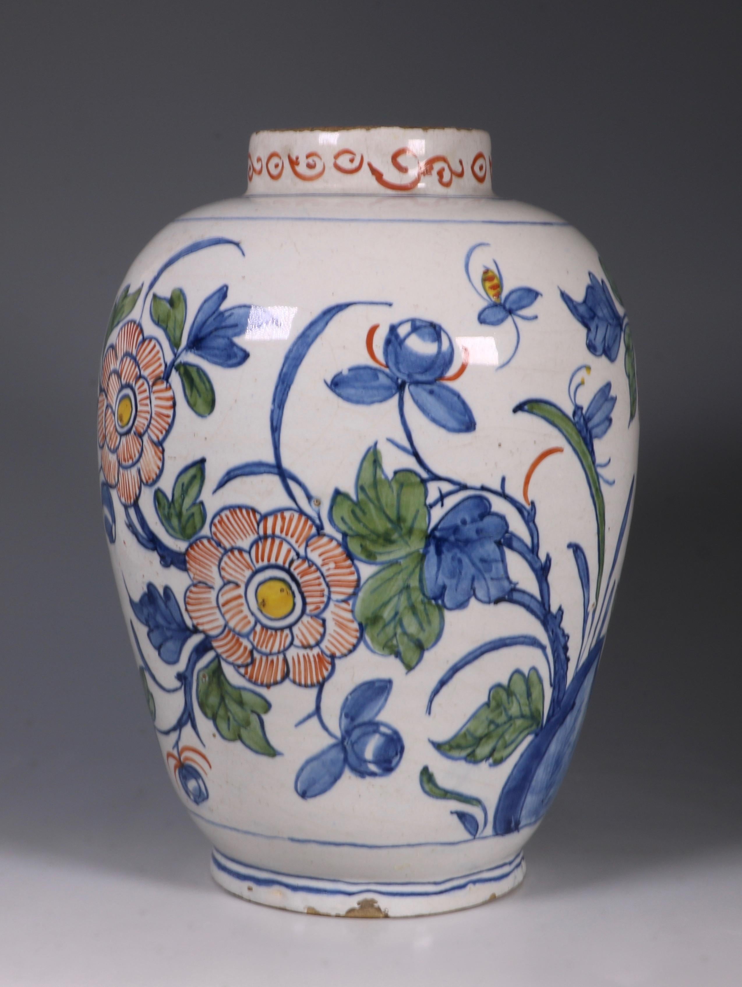 An 18th century Dutch Delft polychrome vase. Decorated with flowering plants issuing from rock work, a mayfly resting on a leaf and another in flight.
Base marked 19 (61).

 