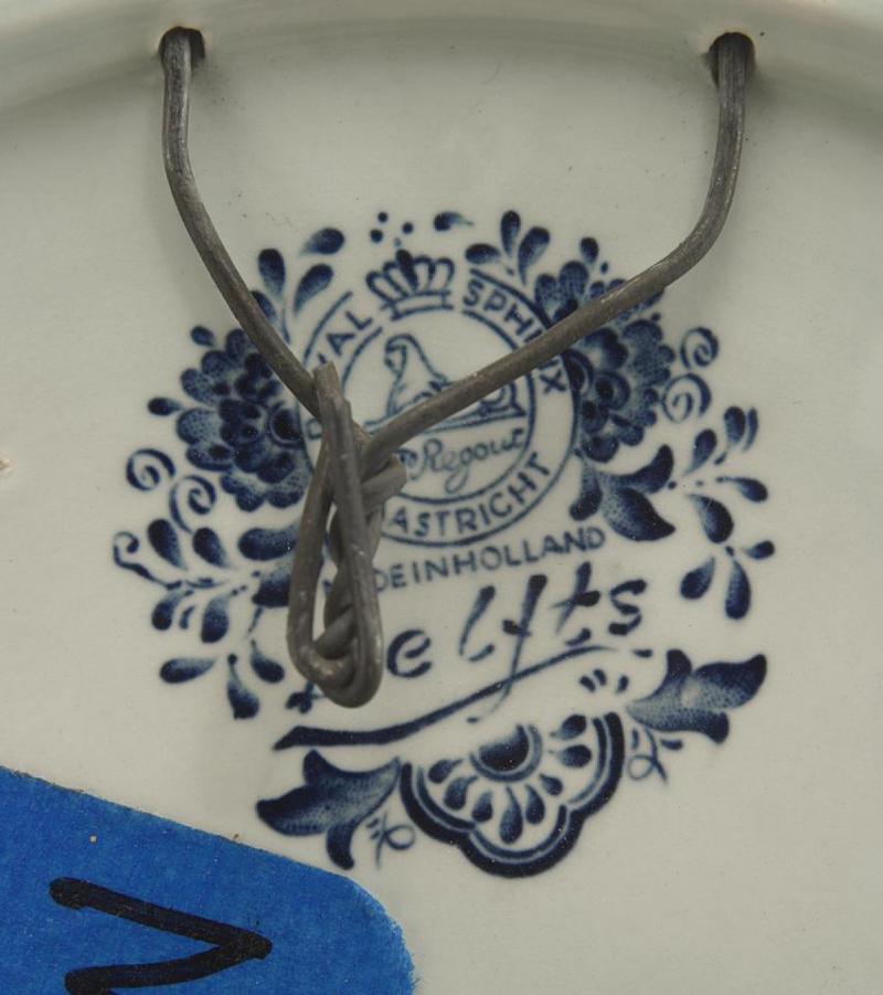 Dutch blue and white Delft porcelain wall plaque (19/20th Century)  with scalloped edge and landscape scene of cottage by canal (signed T. Sonneville) (Related item: 043937B, 043937C).

Condition: Good; Wear consistent with age and use