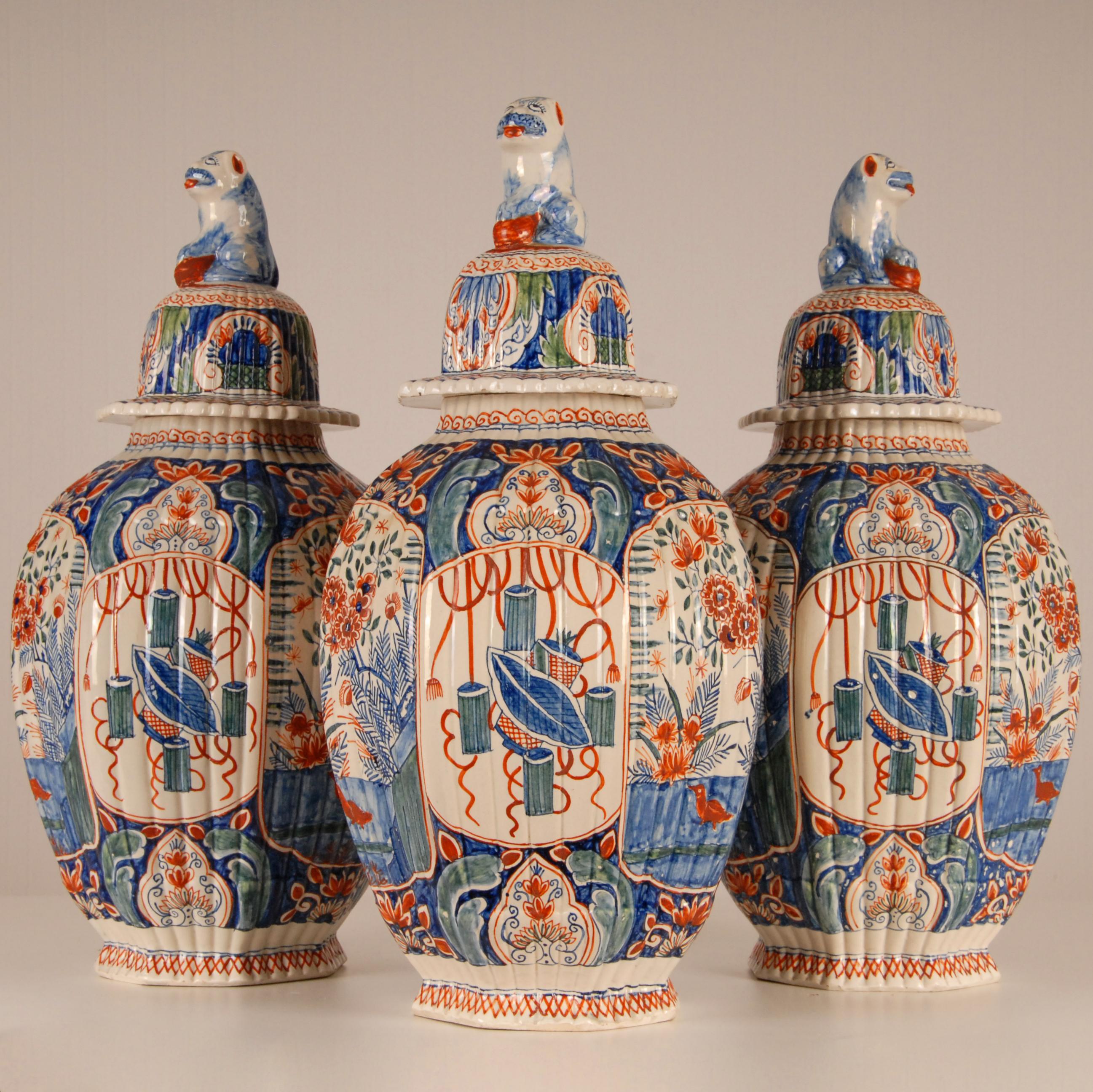 Edme Samson Dutch Delftware.
A garniture of three antique polychrome Reeded Ovoid Vases and Covers.
A garniture of vases in the precious and wanted Cashmere palette
Each decorated on the ovoid body with four elongated panels painted in blue,
