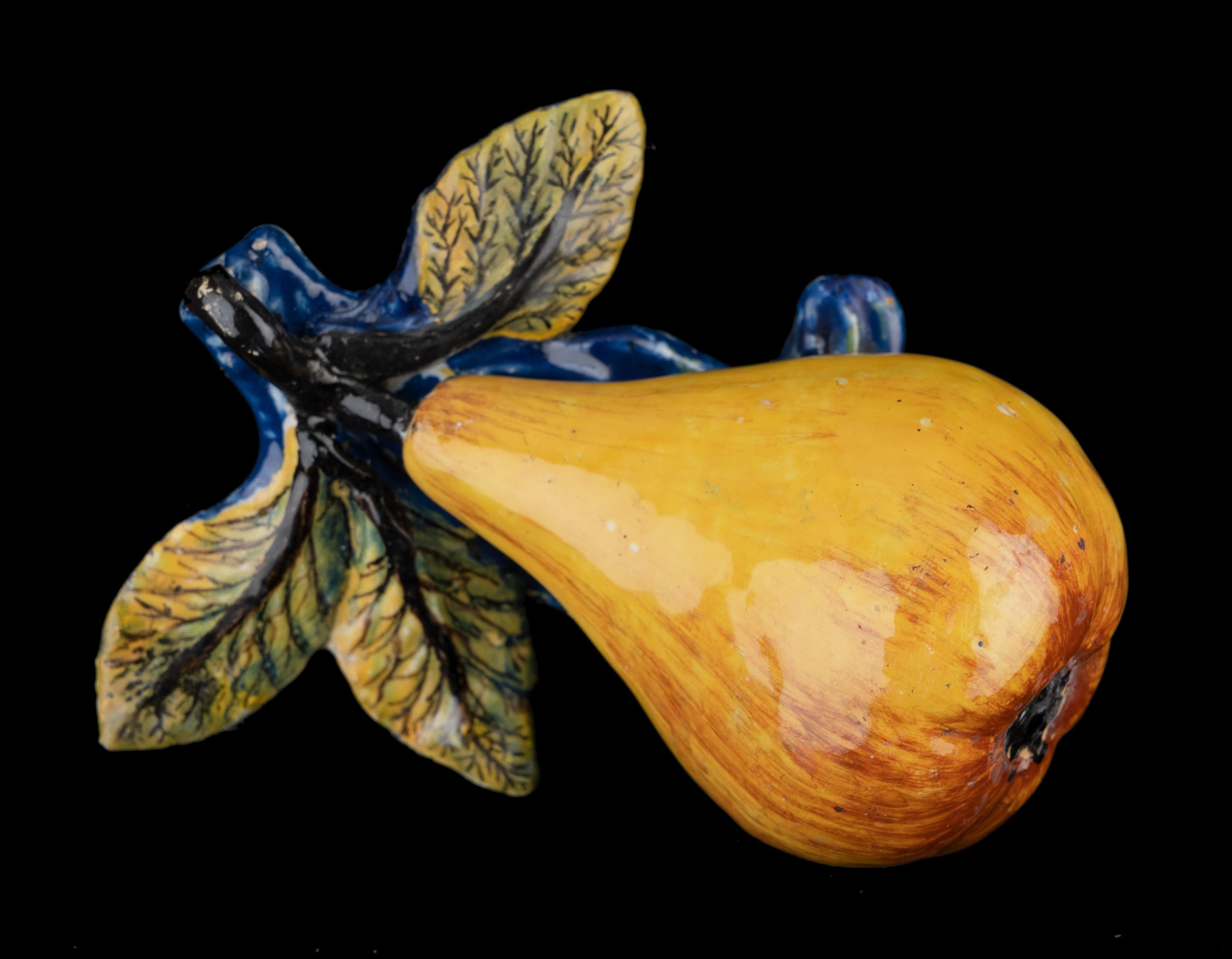 Dutch delftware Pear. Delft, 1750-1780

The pear with stem is modelled on a base of leaves and is painted in realistic colours. 

Dimensions: height 7 cm / 2.75 in., length 12 cm / 4.72 in., width 9 cm / 3.54 in.

Figurines of fruit were