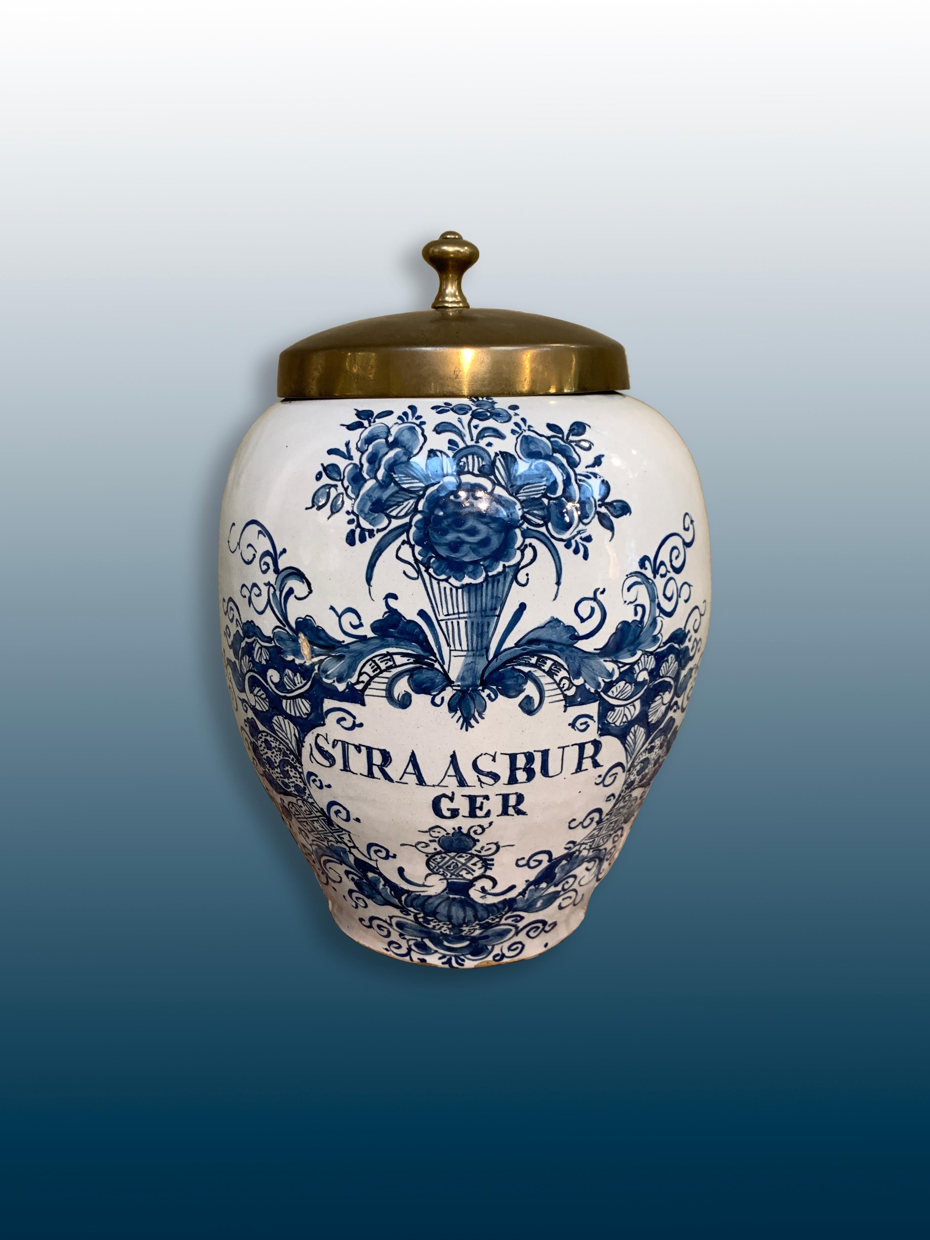 A Dutch Delftware Tobacco jar with a brass lid. 

Origine: Delft, The Netherlands
Date: Second half of the 18th century
Workshop: Unknown

A genuine blue and white tobacco jar for the storage of tobacco.
The brand name: Straasburger, is