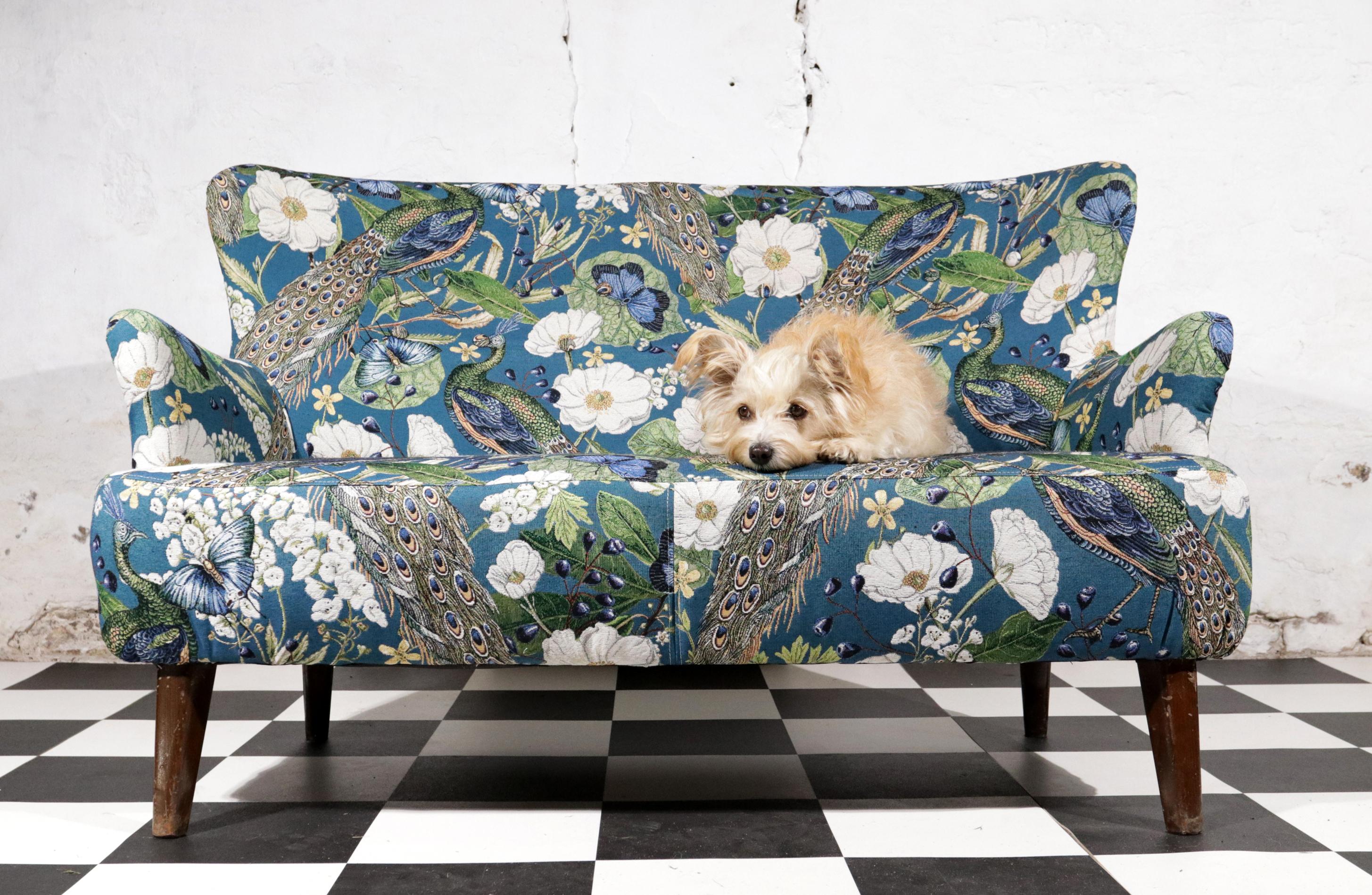 Loveseat designed by Theo Ruth for Artifort in the 1950's.
Reupholstered with a beautiful fine woven gobelin fabric with peacocks, butterflies and flowers.

Dutch designer Theo Ruth was born in 1915 in Maastricht. He trained as a furniture designer