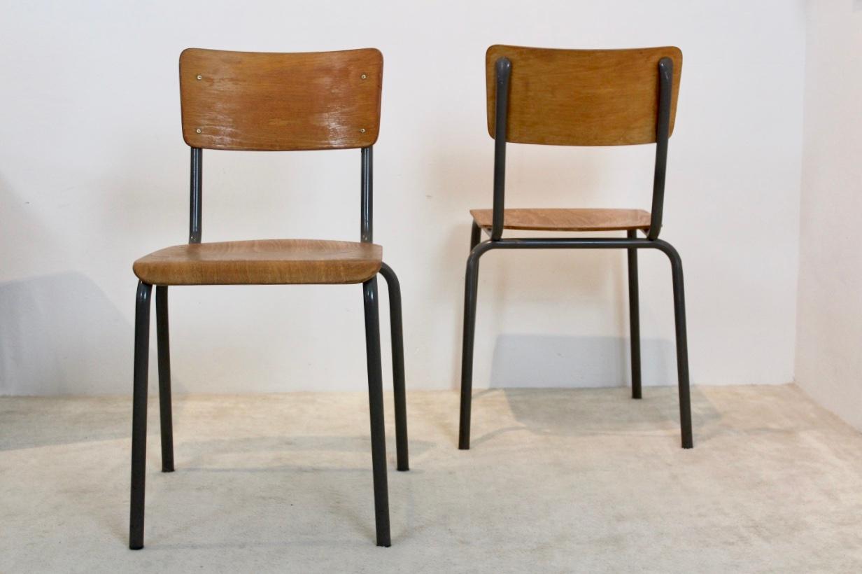 Very comfortable Industrial plywood chairs, produced in Holland in the 1960s. These Dutch design chairs have a dark grey tubular metal frame and beautifully curved plywood seats and backrests. All stackable. Minor wear consistent with age and use,
