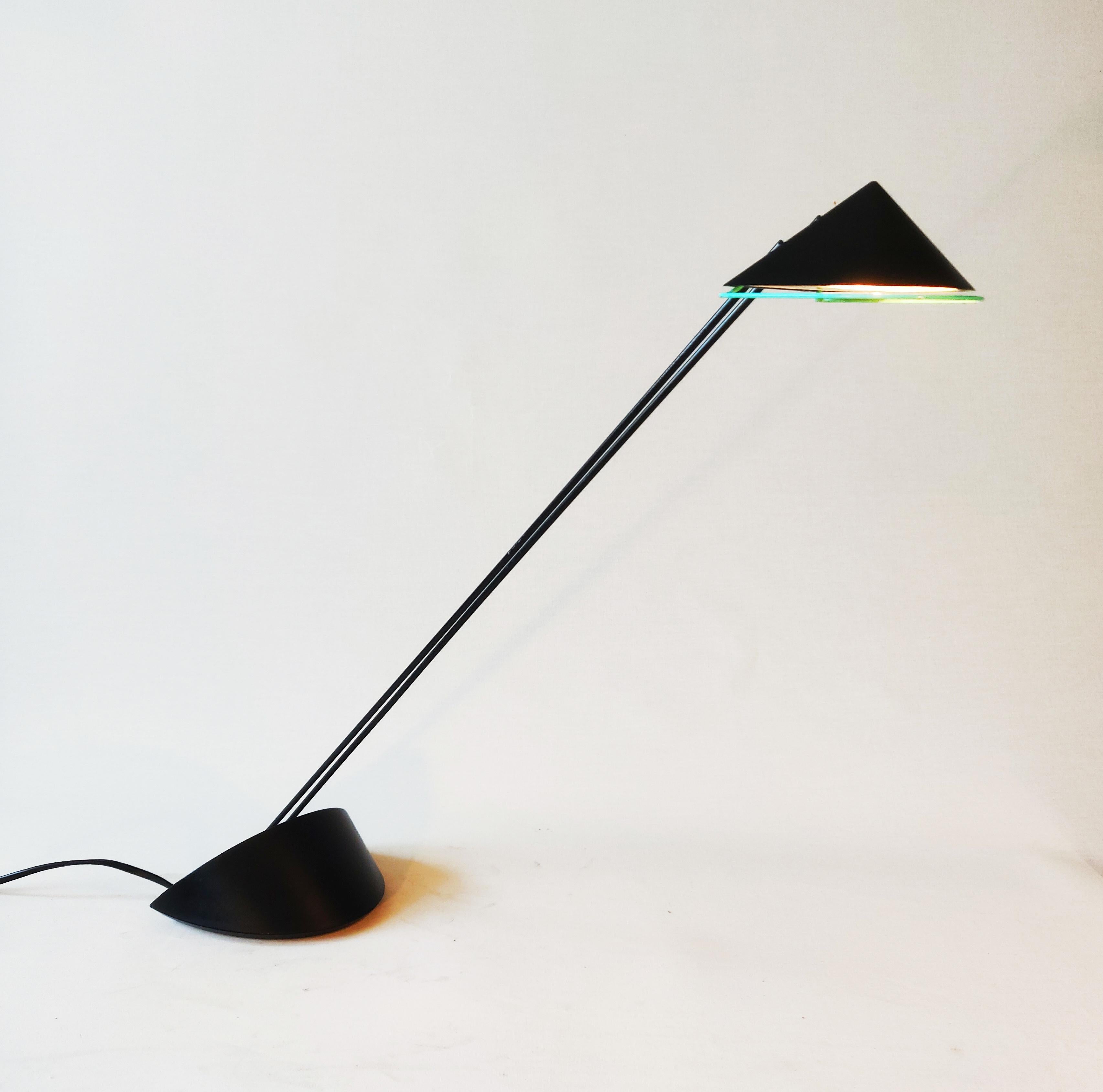 This is a Priola design lamp from the 80s. The lamp was designed by Dutch designer Ad van Berlo and produced by Indoor Amsterdam. The lamp has a pastel green border under the shade and also the on and off button is pastel green. The lamp has real