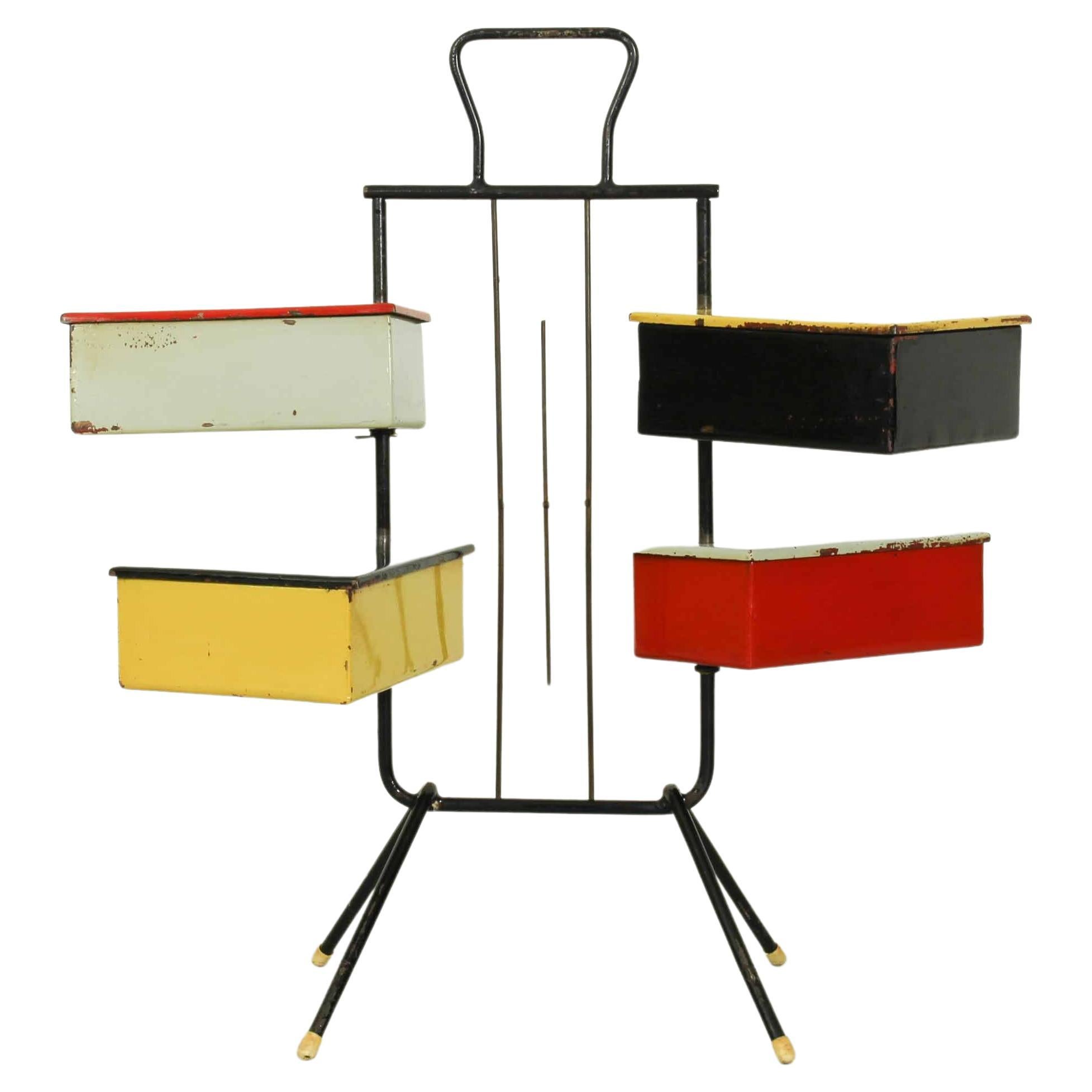 This 1950s sewing stand with 4 boxes was designed by Joos Teders for Metalux. It has four colored metal boxes (that can swivel arount the metal Stand) which gives a Rietveld style to this item. This item has traces of use consistent with age.